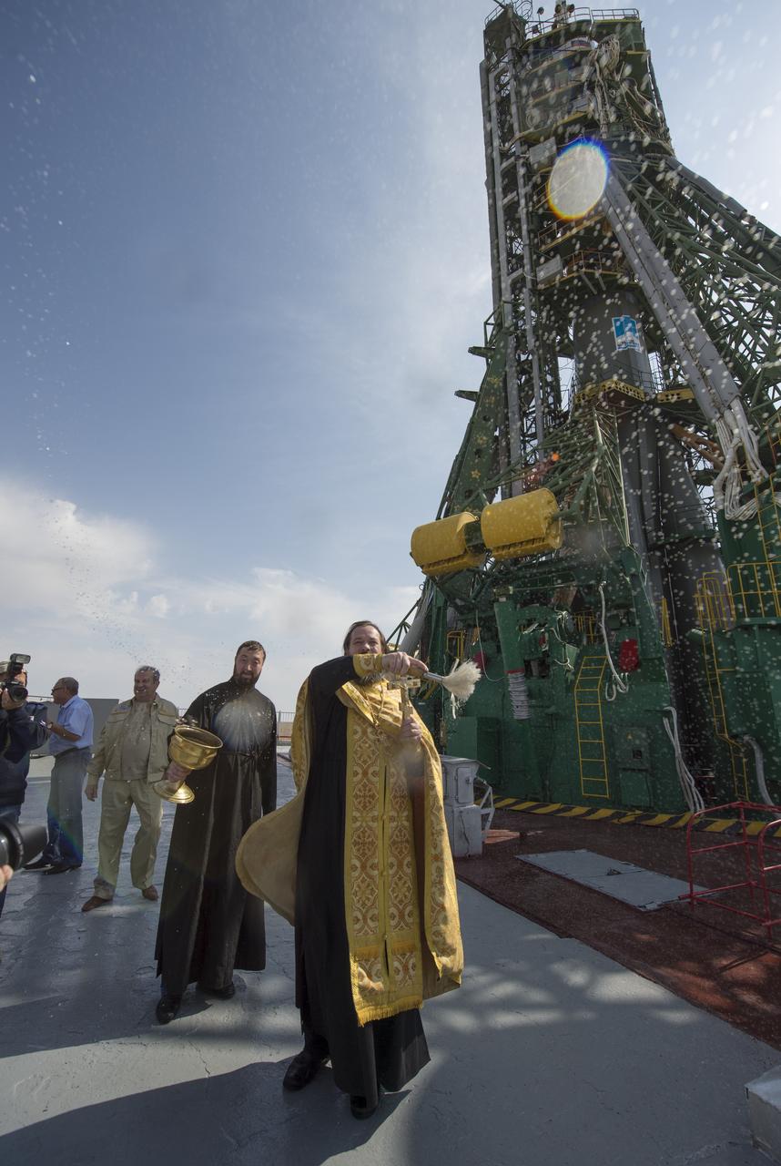An Orthodox priest blesses members of the public at the Baikonur Cosmodrome Launch pad on Tuesday, Sept. 24, 2013 in Baikonur, Kazakhstan. Launch of the Soyuz rocket is scheduled for September 26 and will send Expedition 37/38 Flight Engineer Michael Hopkins of NASA, Soyuz Commander Oleg Kotov and Flight Engineer and Russian Flight Engineer Sergei Ryazansky on a five-month mission aboard the International Space Station. Photo Credit: (NASA/Carla Cioffi)