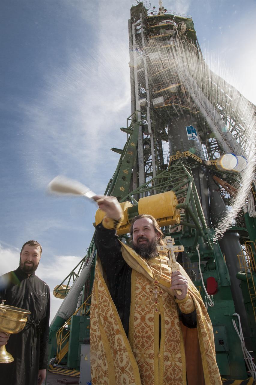 An Orthodox priest blesses members of the public at the the Baikonur Cosmodrome Soyuz launch pad on Tuesday, Sept. 24, 2013 in Baikonur, Kazakhstan.  Launch of the Soyuz rocket is scheduled for September 26 and will send Expedition 37/38 Flight Engineer Michael Hopkins of NASA, Soyuz Commander Oleg Kotov and Flight Engineer and Russian Flight Engineer Sergei Ryazansky on a five-month mission aboard the International Space Station.  Photo Credit: (NASA/Victor Zelentsov)
