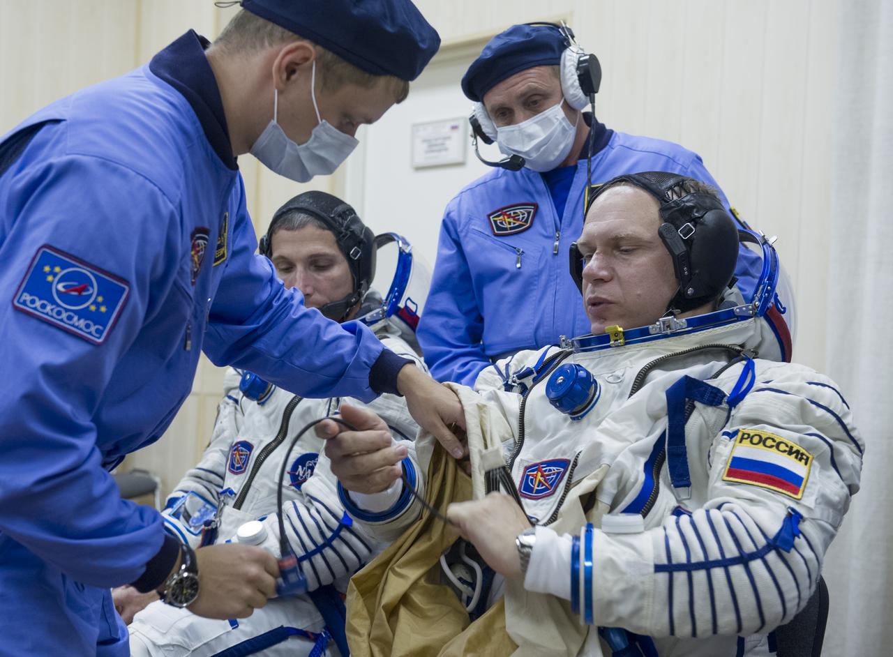 Expedition 37/38 Soyuz Commander Oleg Kotov is fitted into his Russian Sokol suit as he and fellow crewmates NASA Flight Engineer Michael Hopkins and Russian Flight Engineer Sergey Ryazanskiy prepare for their Soyuz launch to the International Space Station, on Wednesday, Sept. 25, 2013, in Baikonur, Kazakhstan. Launch of the Soyuz rocket will send Kotov, Hopkins and Ryazanskiy on a five-month mission aboard the International Space Station.  Photo Credit: (NASA/GCTC/Andrey Shelepin)
