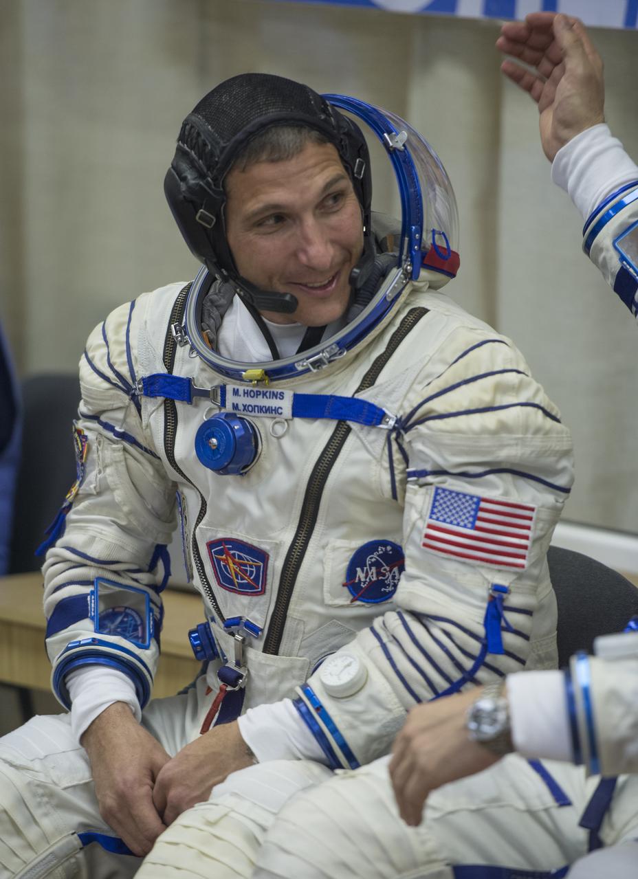 Expedition 37/38 NASA Flight Engineer Michael Hopkins is seen smiling before having his Russian Sokol suit pressure checked ahead of his launch onboard a Soyuz TMA-10M spacecraft to the International Space Station, on Wednesday, Sept. 25, 2013, in Baikonur, Kazakhstan. Launch of the Soyuz rocket will send the Expedition 37/38 crewmates on a five-month mission aboard the International Space Station.  Photo Credit: (NASA/Carla Cioffi)