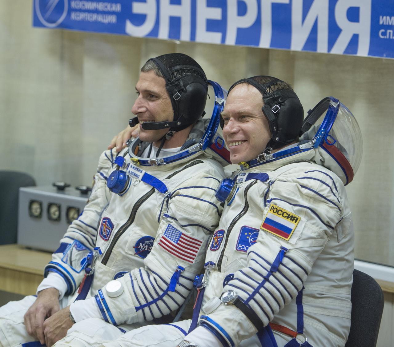 Expedition 37/38 Soyuz Commander Oleg Kotov, right, and NASA Flight Engineer Michael Hopkins pose for a photo before having their Russian Sokol suits pressure checked ahead of their launch onboard a Soyuz TMA-10M spacecraft to the International Space Station, on Wednesday, Sept. 25, 2013, in Baikonur, Kazakhstan. Launch of the Soyuz rocket will send the Expedition 37/38 crewmates on a five-month mission aboard the International Space Station.  Photo Credit: (NASA/Carla Cioffi)
