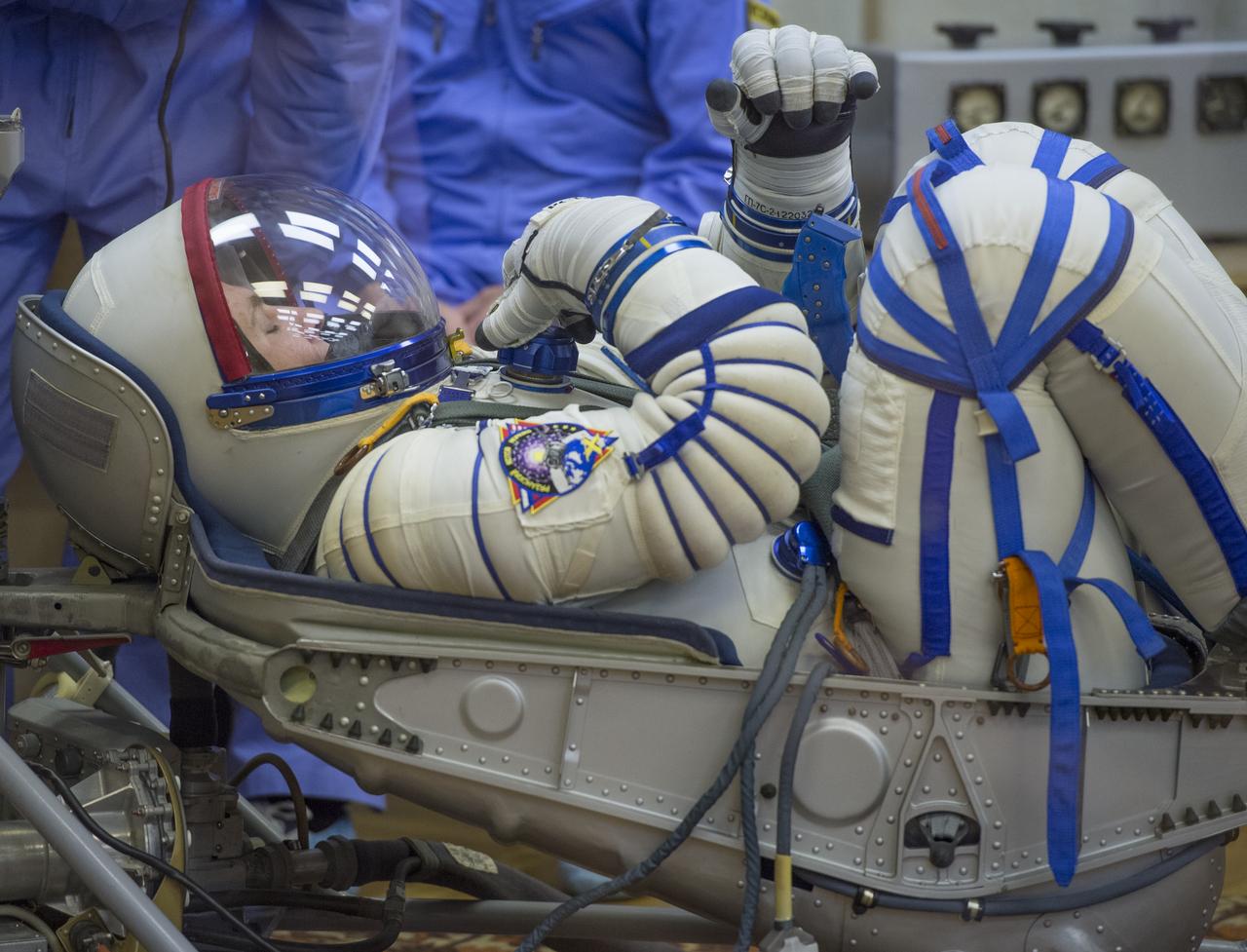 Expedition 37/38 Russian Flight Engineer Sergey Ryazanskiy has his Russian Sokol suit pressure checked ahead of his launch onboard a Soyuz TMA-10M spacecraft to the International Space Station with fellow crewmates NASA Flight Engineer Michael Hopkins and Soyuz Commander Oleg Kotov, on Wednesday, Sept. 25, 2013, in Baikonur, Kazakhstan. Launch of the Soyuz rocket will send the Expedition 37/38 crewmates on a five-month mission aboard the International Space Station.  Photo Credit: (NASA/Carla Cioffi)
