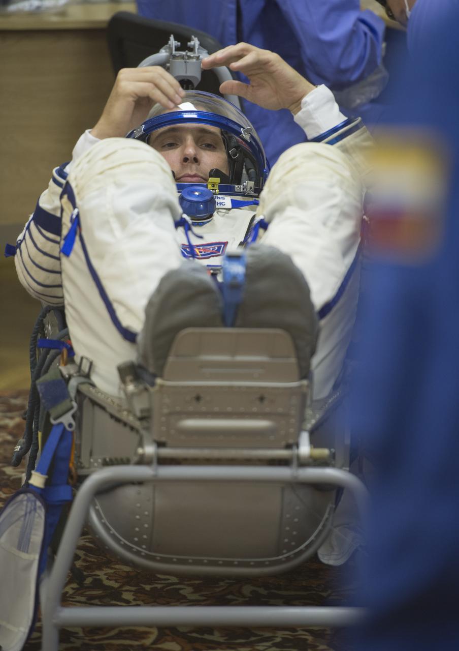 Expedition 37/38 NASA Engineer Michael Hopkins has his Russian Sokol suit pressure checked ahead of his launch onboard a Soyuz TMA-10M spacecraft to the International Space Station with fellow crewmates Russian Flight Engineer Sergey Ryazanskiy and Soyuz Commander Oleg Kotov, on Wednesday, Sept. 25, 2013, in Baikonur, Kazakhstan. Launch of the Soyuz rocket will send the Expedition 37/38 crewmates on a five-month mission aboard the International Space Station.  Photo Credit: (NASA/Carla Cioffi)