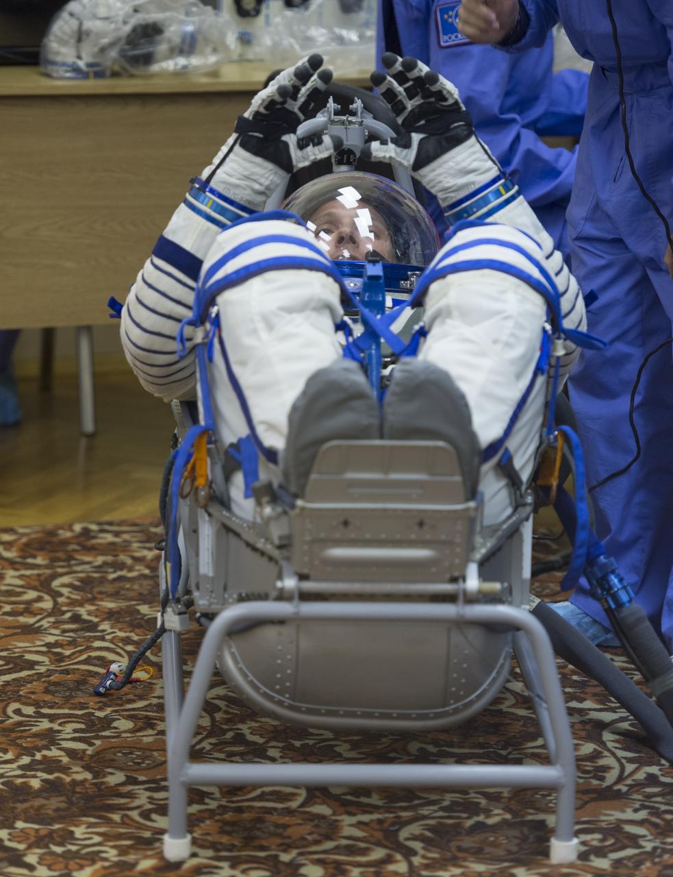 Expedition 37/38 NASA Engineer Michael Hopkins has his Russian Sokol suit pressure checked ahead of his launch onboard a Soyuz TMA-10M spacecraft to the International Space Station with fellow crewmates Russian Flight Engineer Sergey Ryazanskiy and Soyuz Commander Oleg Kotov, on Wednesday, Sept. 25, 2013, in Baikonur, Kazakhstan. Launch of the Soyuz rocket will send the Expedition 37/38 crewmates on a five-month mission aboard the International Space Station.  Photo Credit: (NASA/Carla Cioffi)