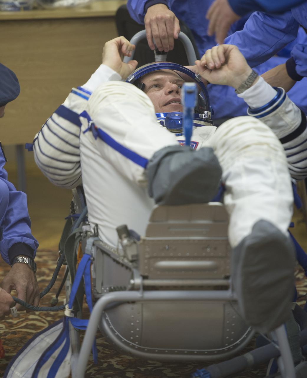 Expedition 37/38 Soyuz Commander Oleg Kotov prepares to have his Russian Sokol suit pressure checked ahead of his launch onboard a Soyuz TMA-10M spacecraft to the International Space Station with fellow crewmates Russian Flight Engineer Sergey Ryazanskiy and NASA Engineer Michael Hopkins, on Wednesday, Sept. 25, 2013, in Baikonur, Kazakhstan. Launch of the Soyuz rocket will send the Expedition 37/38 crewmates on a five-month mission aboard the International Space Station.  Photo Credit: (NASA/Carla Cioffi)
