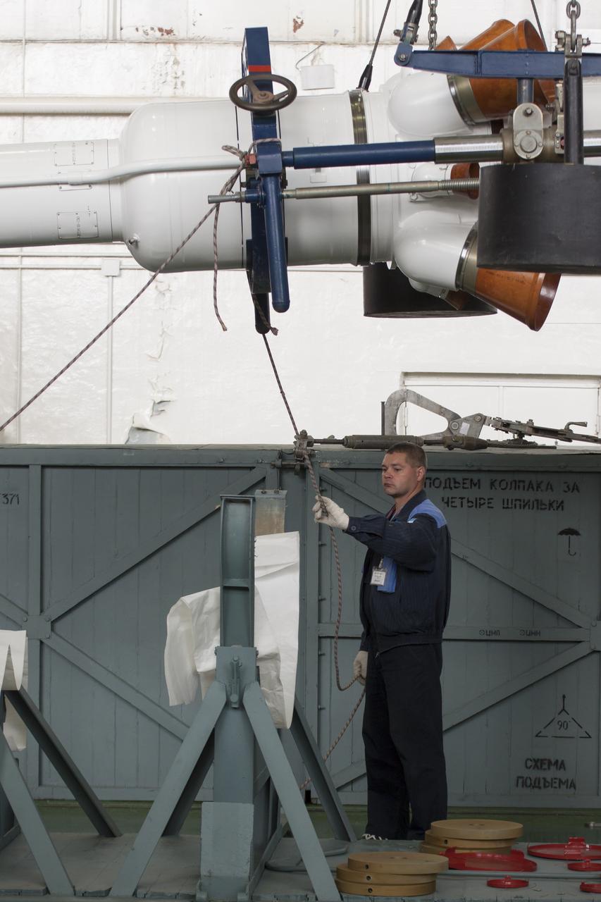 Workers make final preperations to a Soyuz TMA-11M spacecraft on Monday, Nov. 4, 2013, at the Baikonur Cosmodome in Baikonur, Kazakhstan. The rocket is adorned with the logo of the Sochi Olympic Organizing Committee and other related artwork to commemorate the launch of the Olympic torch with the crew for a four-day visit to the station. The torch will return to Earth with another trio of station residents on Nov. 11 and will be part of the torch relay that ends with the lighting of the flame at the Fisht Stadium in Sochi, Russia Feb. 7 to mark the opening of the 2014 Winter Olympics. Photo Credit: (NASA/Victor Zelentsov)