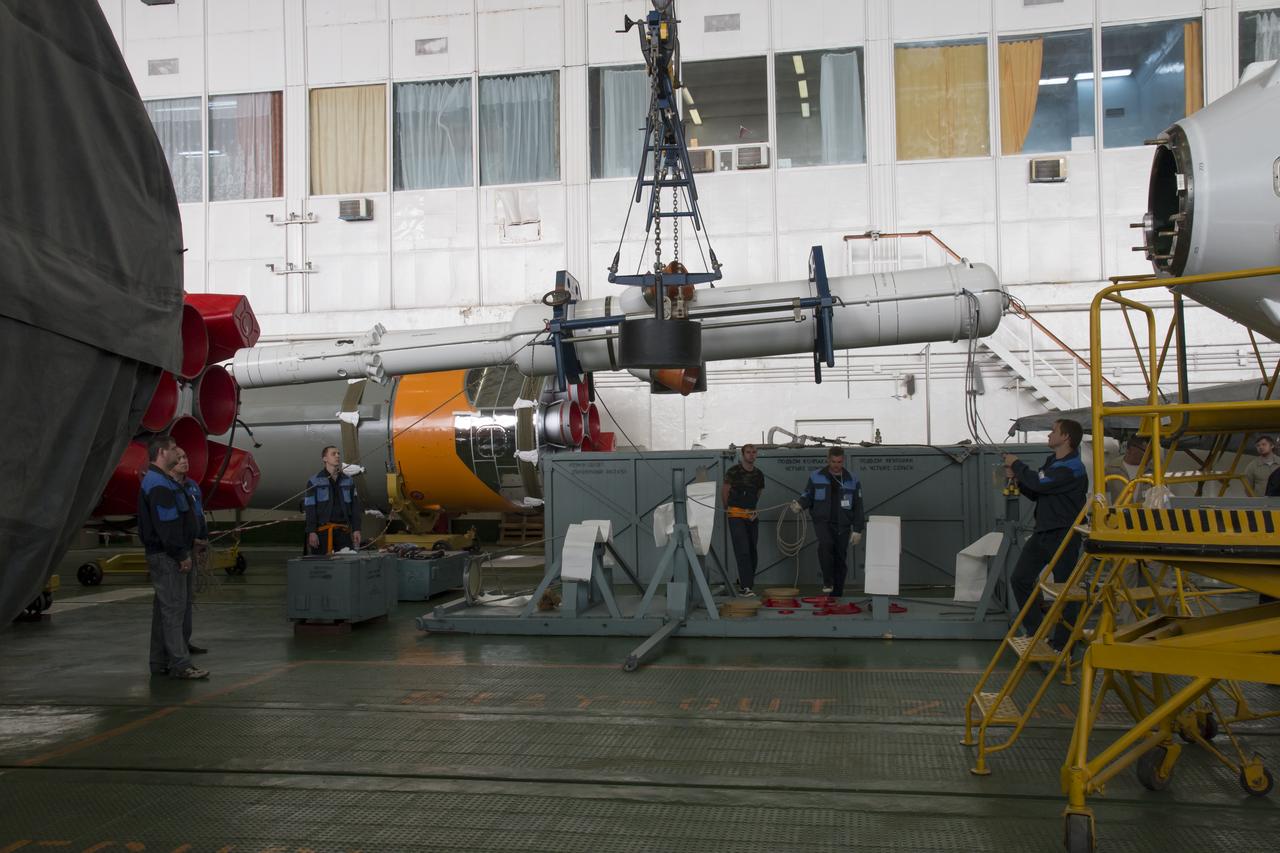 Workers make final preperations to a Soyuz TMA-11M spacecraft on Monday, Nov. 4, 2013, at the Baikonur Cosmodome in Baikonur, Kazakhstan. The rocket is adorned with the logo of the Sochi Olympic Organizing Committee and other related artwork to commemorate the launch of the Olympic torch with the crew for a four-day visit to the station. The torch will return to Earth with another trio of station residents on Nov. 11 and will be part of the torch relay that ends with the lighting of the flame at the Fisht Stadium in Sochi, Russia Feb. 7 to mark the opening of the 2014 Winter Olympics. Photo Credit: (NASA/Victor Zelentsov)