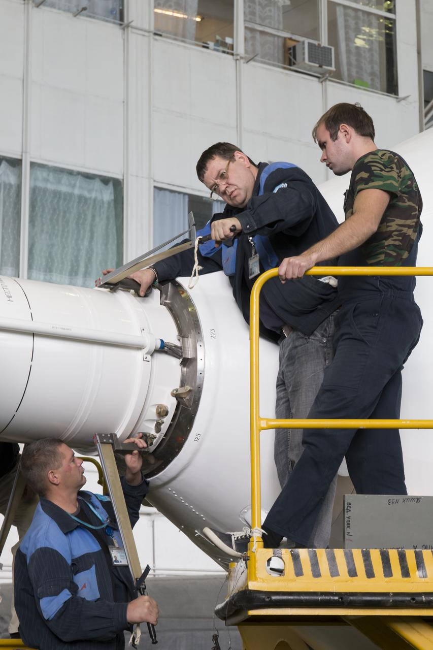 Workers make final preperations to a Soyuz TMA-11M spacecraft on Monday, Nov. 4, 2013, at the Baikonur Cosmodome in Baikonur, Kazakhstan. The rocket is adorned with the logo of the Sochi Olympic Organizing Committee and other related artwork to commemorate the launch of the Olympic torch with the crew for a four-day visit to the station. The torch will return to Earth with another trio of station residents on Nov. 11 and will be part of the torch relay that ends with the lighting of the flame at the Fisht Stadium in Sochi, Russia Feb. 7 to mark the opening of the 2014 Winter Olympics. Photo Credit: (NASA/Victor Zelentsov)