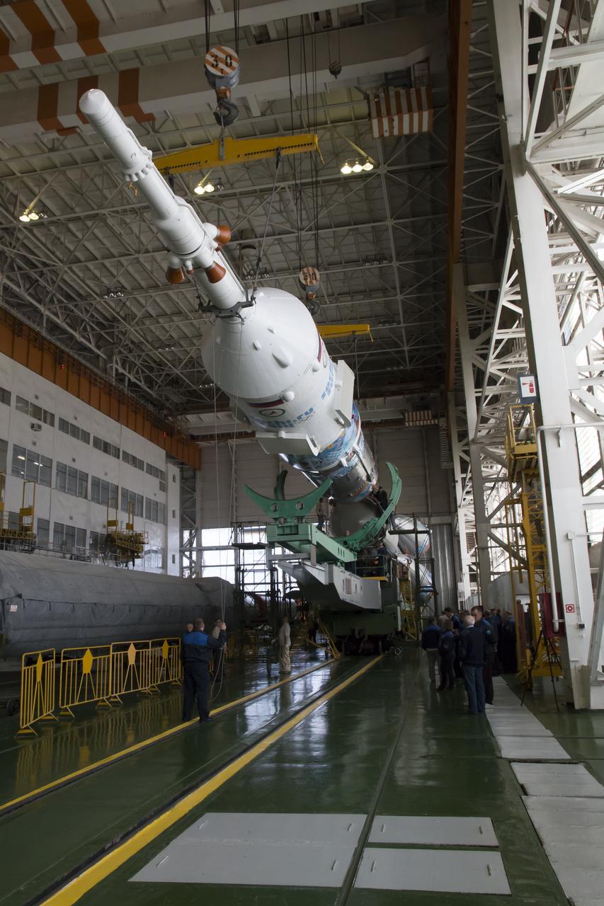 Workers make final preperations to a Soyuz TMA-11M spacecraft on Monday, Nov. 4, 2013, at the Baikonur Cosmodome in Baikonur, Kazakhstan. The rocket is adorned with the logo of the Sochi Olympic Organizing Committee and other related artwork to commemorate the launch of the Olympic torch with the crew for a four-day visit to the station. The torch will return to Earth with another trio of station residents on Nov. 11 and will be part of the torch relay that ends with the lighting of the flame at the Fisht Stadium in Sochi, Russia Feb. 7 to mark the opening of the 2014 Winter Olympics. Photo Credit: (NASA/Victor Zelentsov)