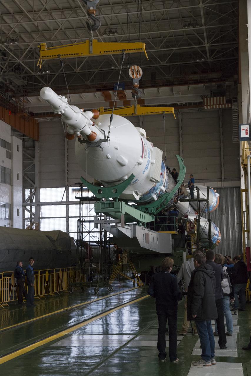 Workers make final preperations to a Soyuz TMA-11M spacecraft on Monday, Nov. 4, 2013, at the Baikonur Cosmodome in Baikonur, Kazakhstan. The rocket is adorned with the logo of the Sochi Olympic Organizing Committee and other related artwork to commemorate the launch of the Olympic torch with the crew for a four-day visit to the station. The torch will return to Earth with another trio of station residents on Nov. 11 and will be part of the torch relay that ends with the lighting of the flame at the Fisht Stadium in Sochi, Russia Feb. 7 to mark the opening of the 2014 Winter Olympics. Photo Credit: (NASA/Victor Zelentsov)