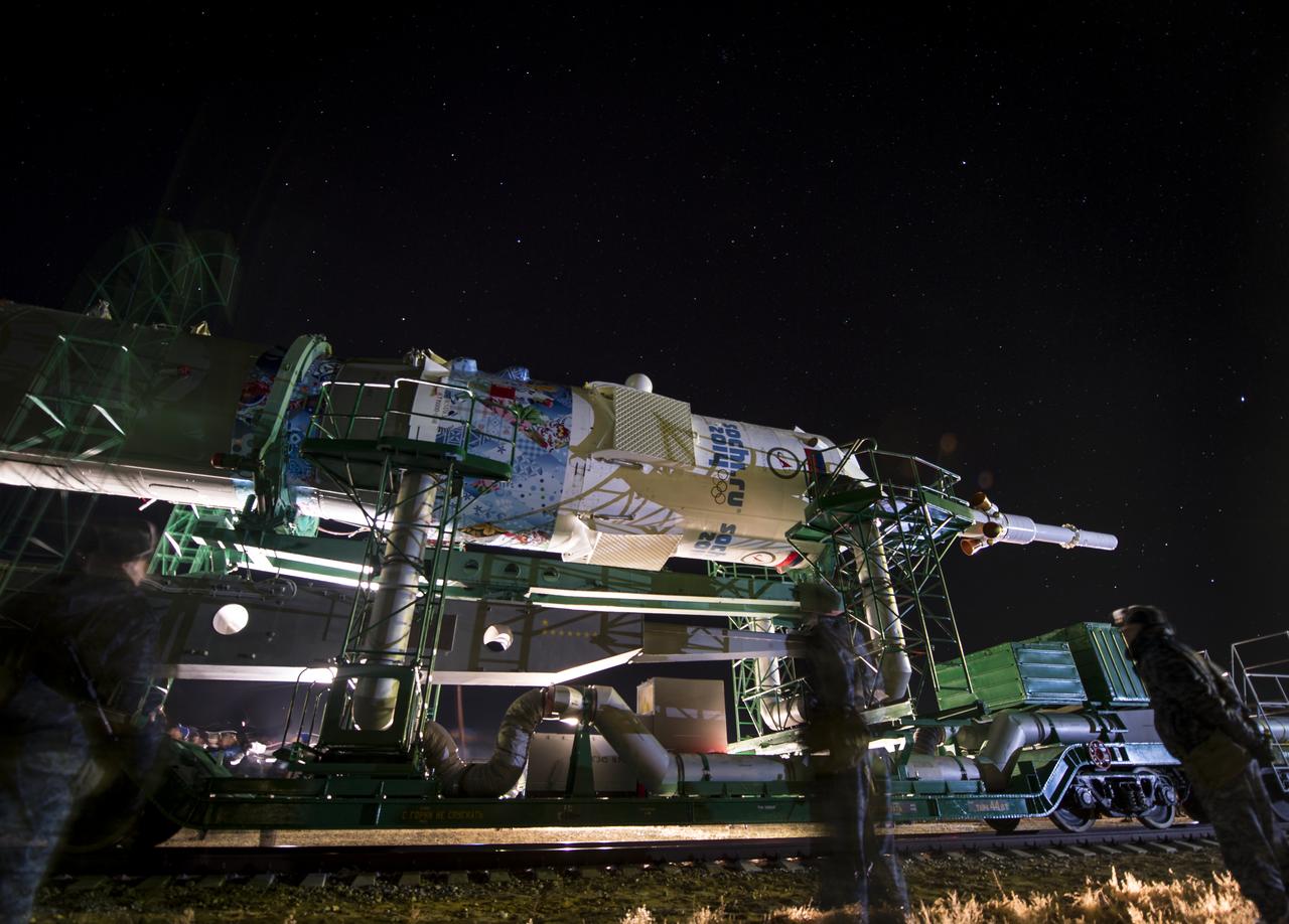 The Soyuz TMA-11M rocket, adorned with the logo of the Sochi Olympic Organizing Committee and other related artwork, is rolled out to the launch pad by train on Tuesday, Nov. 5, 2013, at the Baikonur Cosmodrome in Kazakhstan. Launch of the Soyuz rocket is scheduled for November 7 and will send Expedition 38 Soyuz Commander Mikhail Tyurin of Roscosmos, Flight Engineer Rick Mastracchio of NASA and Flight Engineer Koichi Wakata of the Japan Aerospace Exploration Agency on a six-month mission aboard the International Space Station.  Photo Credit: (NASA/Bill Ingalls)