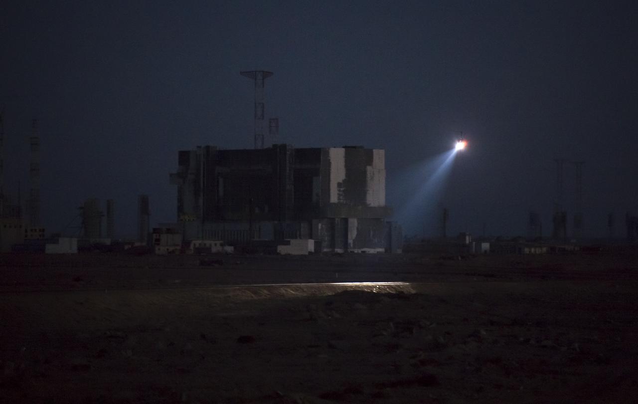 A police helicopter flies along the railway ahead of the Soyuz TMA-11M rocket being rolled out to the launch pad by train on Tuesday, Nov. 5, 2013, at the Baikonur Cosmodrome in Kazakhstan. Launch of the Soyuz rocket is scheduled for November 7 and will send Expedition 38 Soyuz Commander Mikhail Tyurin of Roscosmos, Flight Engineer Rick Mastracchio of NASA and Flight Engineer Koichi Wakata of the Japan Aerospace Exploration Agency on a six-month mission aboard the International Space Station.  Photo Credit: (NASA/Bill Ingalls)