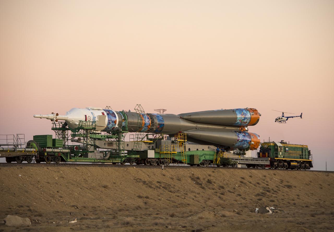The Soyuz TMA-11M rocket, adorned with the logo of the Sochi Olympic Organizing Committee and other related artwork, is rolled out to the launch pad by train on Tuesday, Nov. 5, 2013, at the Baikonur Cosmodrome in Kazakhstan. Launch of the Soyuz rocket is scheduled for November 7 and will send Expedition 38 Soyuz Commander Mikhail Tyurin of Roscosmos, Flight Engineer Rick Mastracchio of NASA and Flight Engineer Koichi Wakata of the Japan Aerospace Exploration Agency on a six-month mission aboard the International Space Station.  Photo Credit: (NASA/Bill Ingalls)