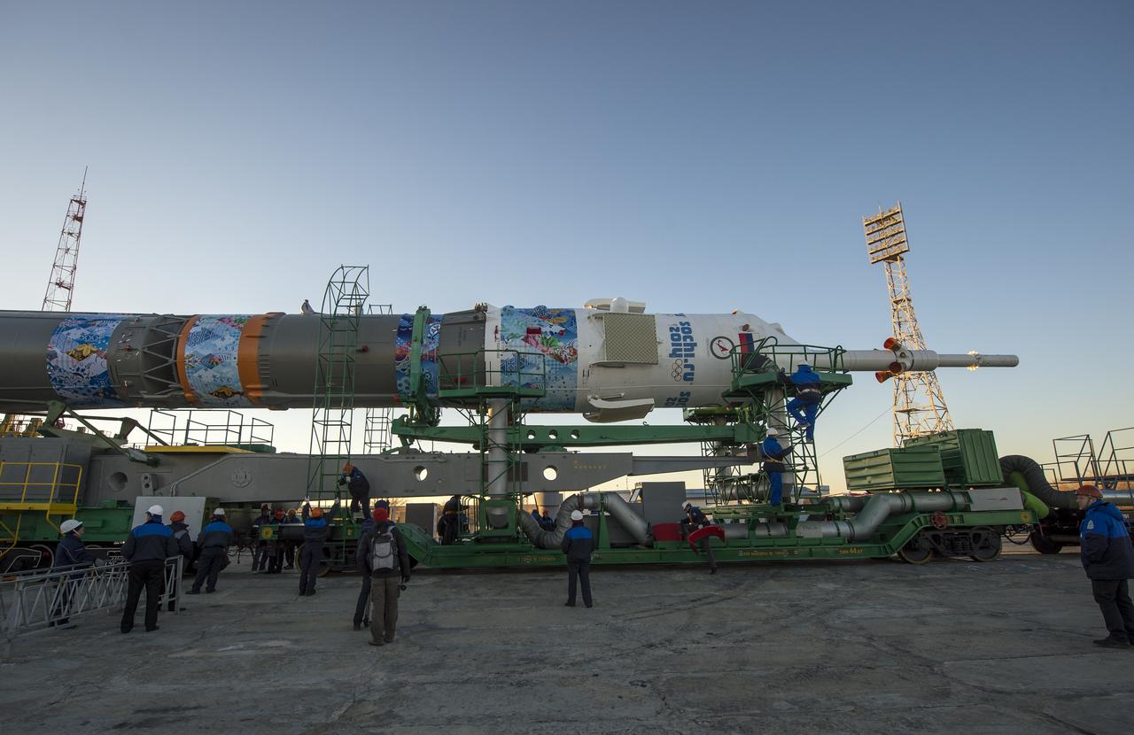 The Soyuz TMA-11M rocket, adorned with the logo of the Sochi Olympic Organizing Committee and other related artwork, arrives at the launch pad by train on Tuesday, Nov. 5, 2013, at the Baikonur Cosmodrome in Kazakhstan. Launch of the Soyuz rocket is scheduled for November 7 and will send Expedition 38 Soyuz Commander Mikhail Tyurin of Roscosmos, Flight Engineer Rick Mastracchio of NASA and Flight Engineer Koichi Wakata of the Japan Aerospace Exploration Agency on a six-month mission aboard the International Space Station.  Photo Credit: (NASA/Bill Ingalls)