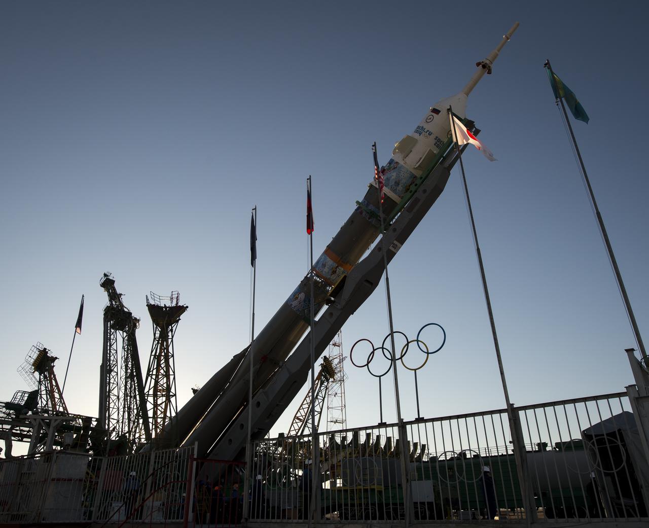 The Olympic rings are seen as the Soyuz TMA-11M rocket is erected into position at the launch pad on Tuesday, Nov. 5, 2013, at the Baikonur Cosmodrome in Kazakhstan. Launch of the Soyuz rocket is scheduled for November 7 and will send Expedition 38 Soyuz Commander Mikhail Tyurin of Roscosmos, Flight Engineer Rick Mastracchio of NASA and Flight Engineer Koichi Wakata of the Japan Aerospace Exploration Agency on a six-month mission aboard the International Space Station.  Photo Credit: (NASA/Bill Ingalls)
