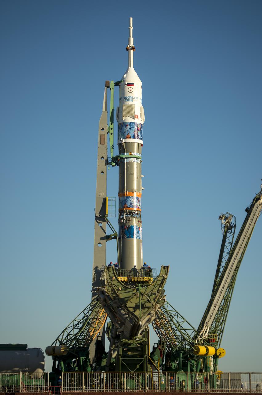 The Soyuz TMA-11M rocket, adorned with the logo of the Sochi Olympic Organizing Committee and other related artwork, is seen after being erected into position at the launch pad on Tuesday, Nov. 5, 2013, at the Baikonur Cosmodrome in Kazakhstan. Launch of the Soyuz rocket is scheduled for November 7 and will send Expedition 38 Soyuz Commander Mikhail Tyurin of Roscosmos, Flight Engineer Rick Mastracchio of NASA and Flight Engineer Koichi Wakata of the Japan Aerospace Exploration Agency on a six-month mission aboard the International Space Station.  Photo Credit: (NASA/Bill Ingalls)