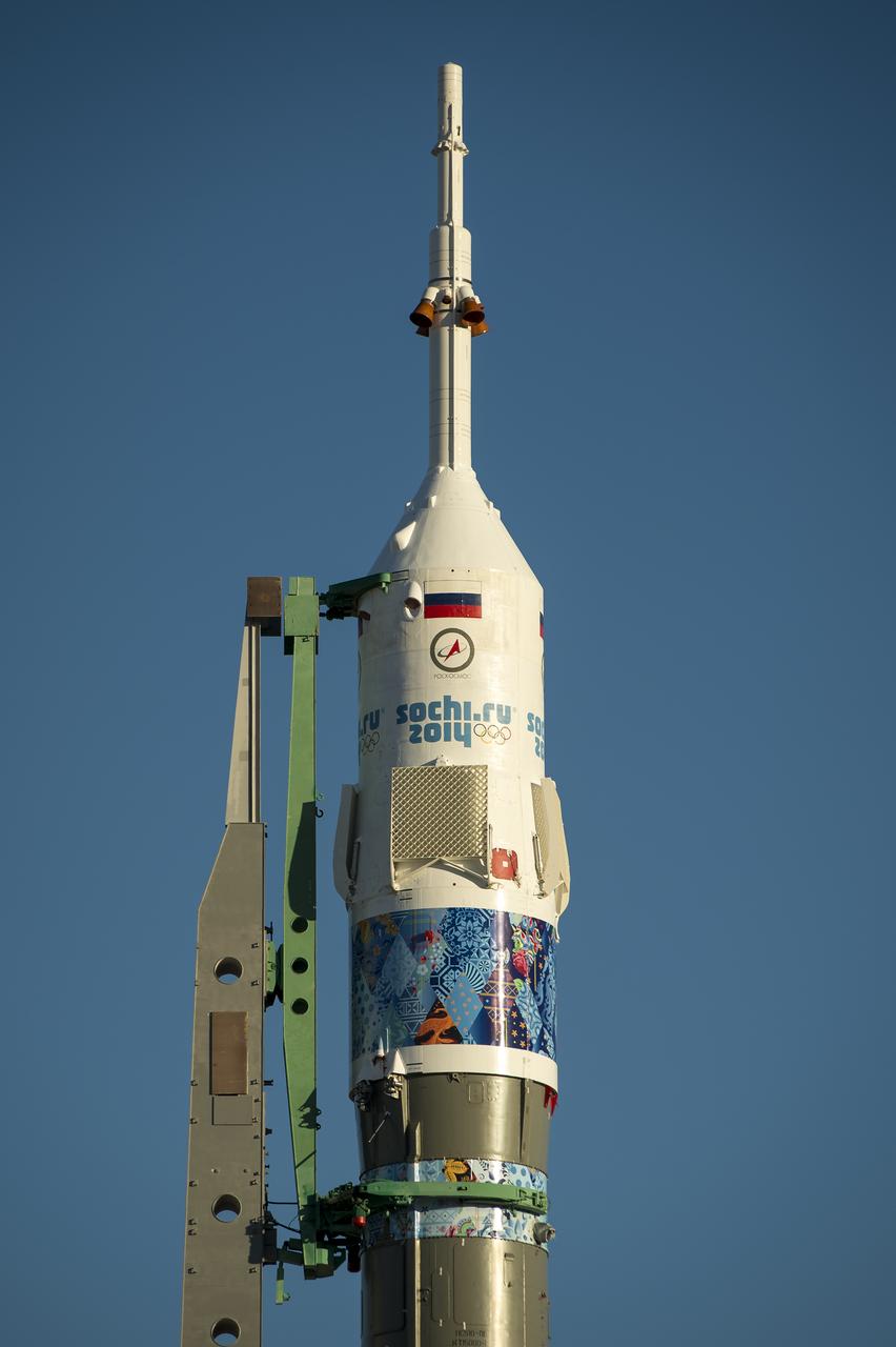 The Soyuz TMA-11M rocket, adorned with the logo of the Sochi Olympic Organizing Committee and other related artwork, is seen after being erected into position at the launch pad on Tuesday, Nov. 5, 2013, at the Baikonur Cosmodrome in Kazakhstan. Launch of the Soyuz rocket is scheduled for November 7 and will send Expedition 38 Soyuz Commander Mikhail Tyurin of Roscosmos, Flight Engineer Rick Mastracchio of NASA and Flight Engineer Koichi Wakata of the Japan Aerospace Exploration Agency on a six-month mission aboard the International Space Station.  Photo Credit: (NASA/Bill Ingalls)