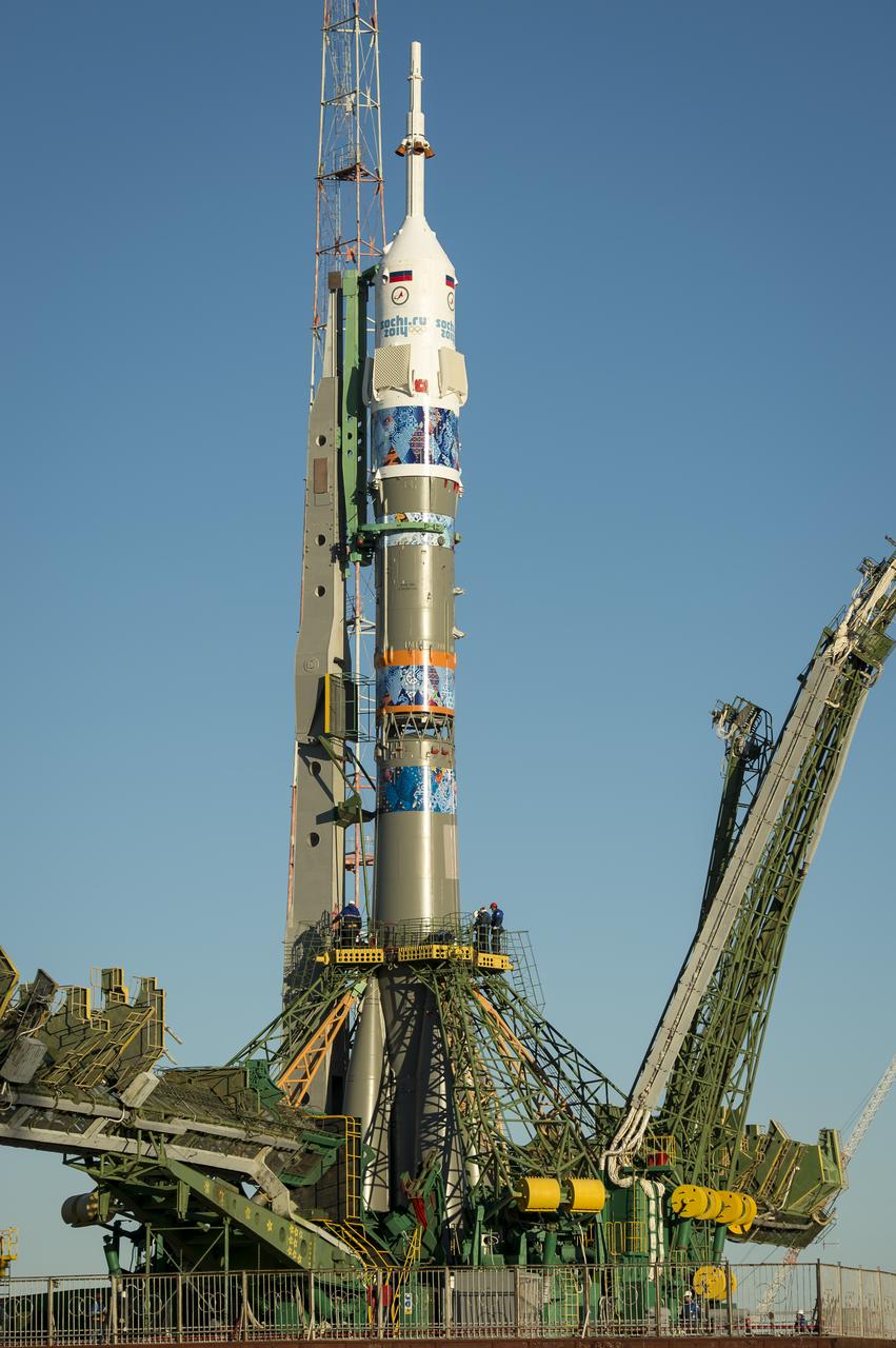 The Soyuz TMA-11M rocket, adorned with the logo of the Sochi Olympic Organizing Committee and other related artwork, is seen after being erected into position at the launch pad on Tuesday, Nov. 5, 2013, at the Baikonur Cosmodrome in Kazakhstan. Launch of the Soyuz rocket is scheduled for November 7 and will send Expedition 38 Soyuz Commander Mikhail Tyurin of Roscosmos, Flight Engineer Rick Mastracchio of NASA and Flight Engineer Koichi Wakata of the Japan Aerospace Exploration Agency on a six-month mission aboard the International Space Station.  Photo Credit: (NASA/Bill Ingalls)