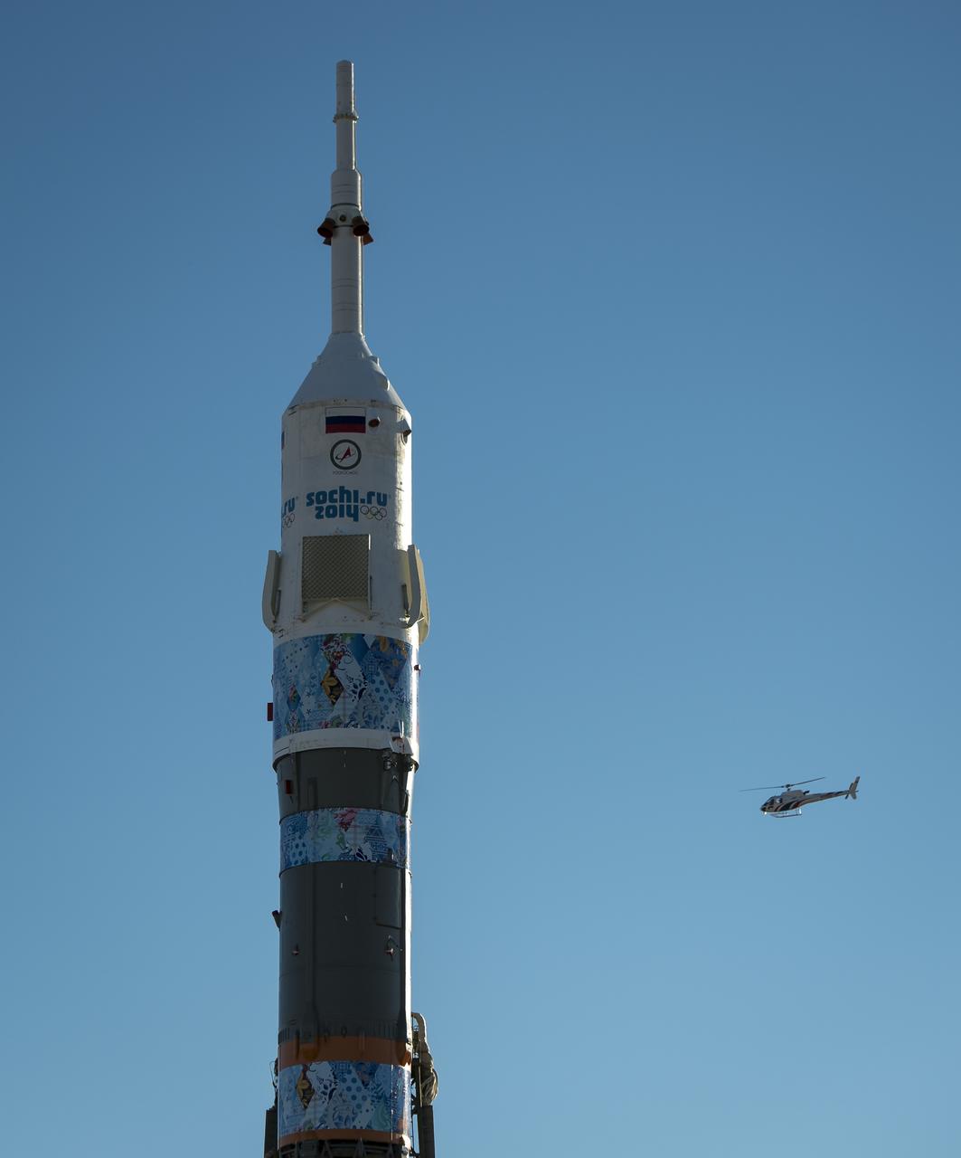 The Soyuz TMA-11M rocket, adorned with the logo of the Sochi Olympic Organizing Committee and other related artwork, is seen after being erected into position at the launch pad on Tuesday, Nov. 5, 2013, at the Baikonur Cosmodrome in Kazakhstan. Launch of the Soyuz rocket is scheduled for November 7 and will send Expedition 38 Soyuz Commander Mikhail Tyurin of Roscosmos, Flight Engineer Rick Mastracchio of NASA and Flight Engineer Koichi Wakata of the Japan Aerospace Exploration Agency on a six-month mission aboard the International Space Station.  Photo Credit: (NASA/Bill Ingalls)
