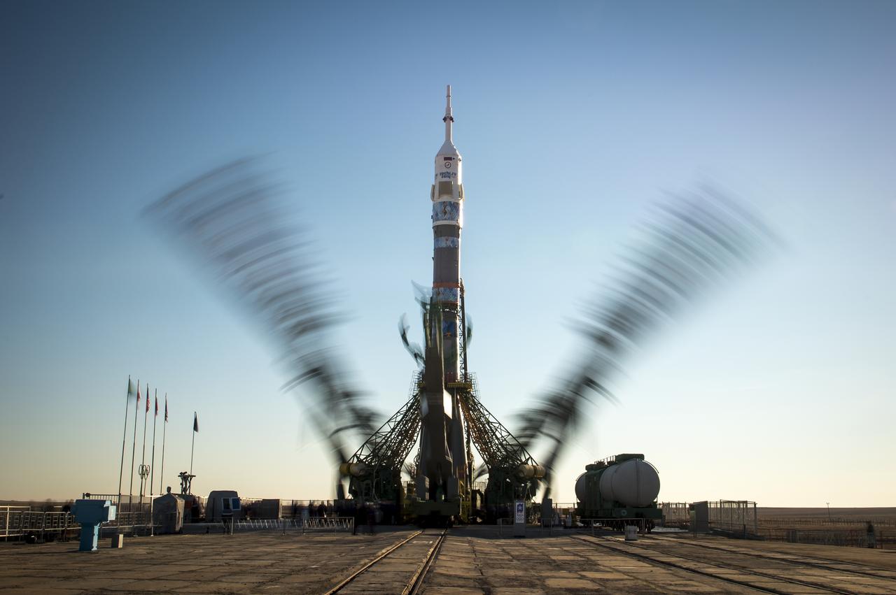 The Soyuz TMA-11M rocket, adorned with the logo of the Sochi Olympic Organizing Committee and other related artwork, is seen in this long exposure photograph, as the service structure arms are raised into position at the launch pad on Tuesday, Nov. 5, 2013, Baikonur Cosmodrome in Kazakhstan. Launch of the Soyuz rocket is scheduled for November 7 and will send Expedition 38 Soyuz Commander Mikhail Tyurin of Roscosmos, Flight Engineer Rick Mastracchio of NASA and Flight Engineer Koichi Wakata of the Japan Aerospace Exploration Agency on a six-month mission aboard the International Space Station.  Photo Credit: (NASA/Bill Ingalls)