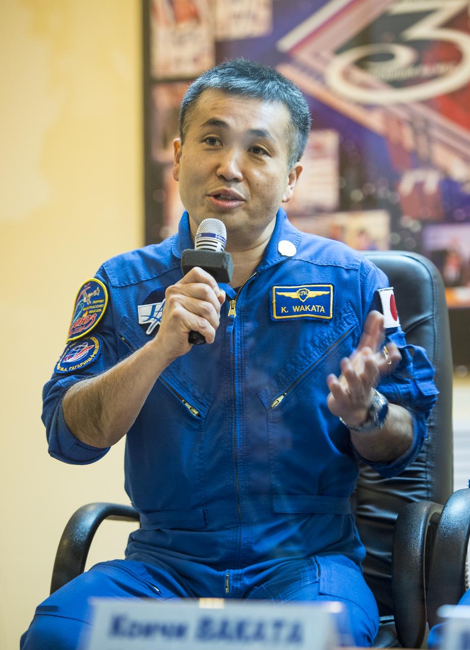 Expedition 38 Flight Engineer Koichi Wakata of the Japan Aerospace Exploration Agency is seen in quarantine, behind glass, during the final press conference held a day ahead of his launch with fellow crew mates, Expedition 38 Soyuz Commander Mikhail Tyurin of Roscosmos, and, Flight Engineer Rick Mastracchio of NASA, to the International Space Station, Wednesday, Nov. 6, 2013 at the Cosmonaut Hotel in Baikonur, Kazakhstan.  Photo Credit: (NASA/Bill Ingalls)