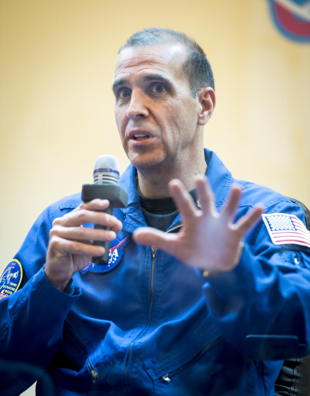 Expedition 38 Flight Engineer Rick Mastracchio of NASA talks, while in quarantine behind glass, during the final press conference held a day ahead of his launch with fellow crew mates, Soyuz Commander Mikhail Tyurin of Roscosmos, and, Flight Engineer Koichi Wakata of the Japan Aerospace Exploration Agency, to the International Space Station, Wednesday, Nov. 6, 2013 at the Cosmonaut Hotel in Baikonur, Kazakhstan. Photo Credit: (NASA/Bill Ingalls)