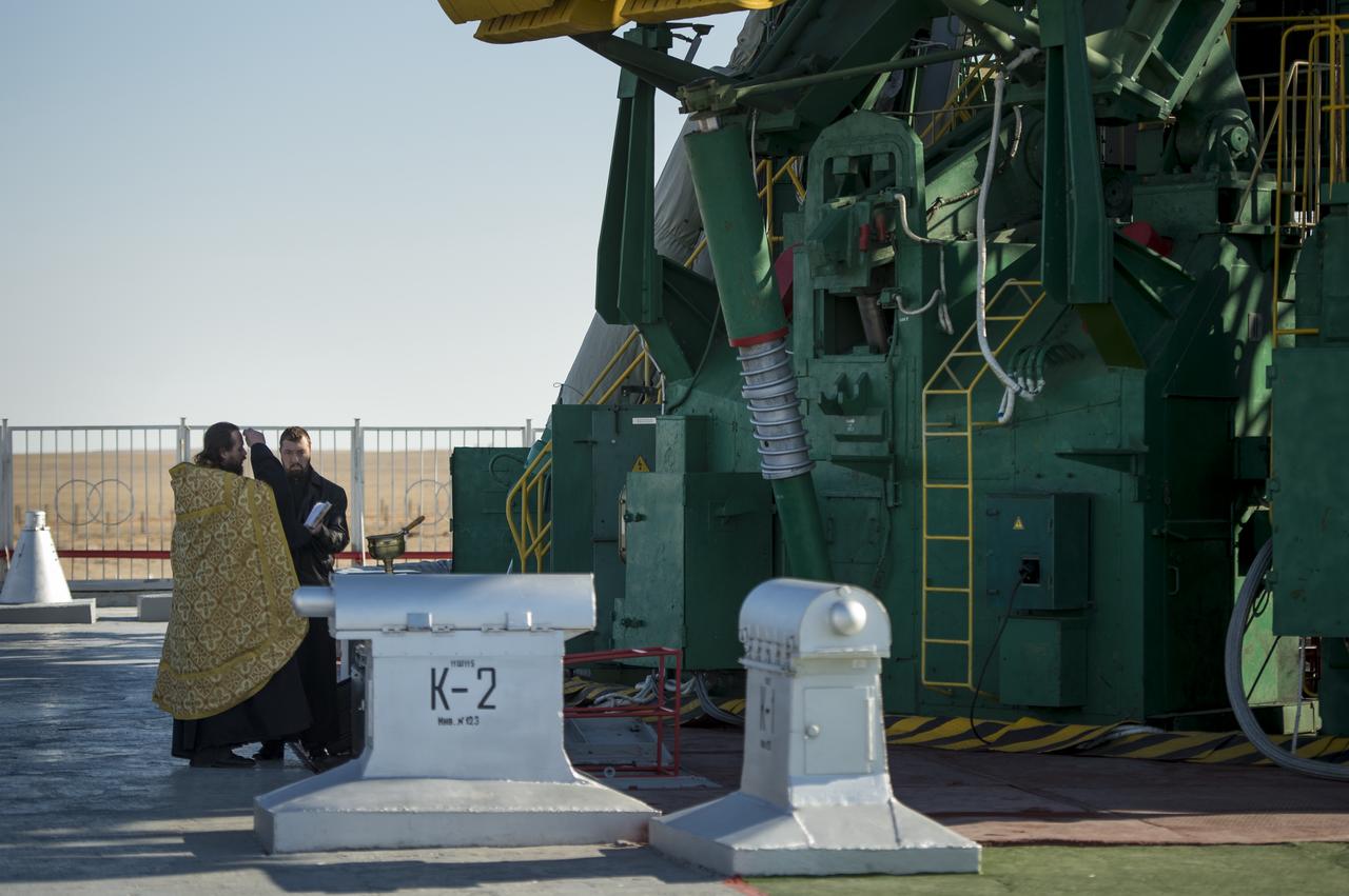 An Orthodox priest blesses the Soyuz rocket at the Baikonur Cosmodrome Launch pad on Wednesday, Nov. 6, 2013 in Kazakhstan. The launch of the Soyuz spacecraft with Expedition 38 Soyuz Commander Mikhail Tyurin of Roscosmos, Flight Engineer Koichi Wakata of the Japan Aerospace Exploration Agency, and, Flight Engineer Rick Mastracchio of NASA, is scheduled for Thursday, Nov. 7.  Photo Credit (NASA/Bill Ingalls)