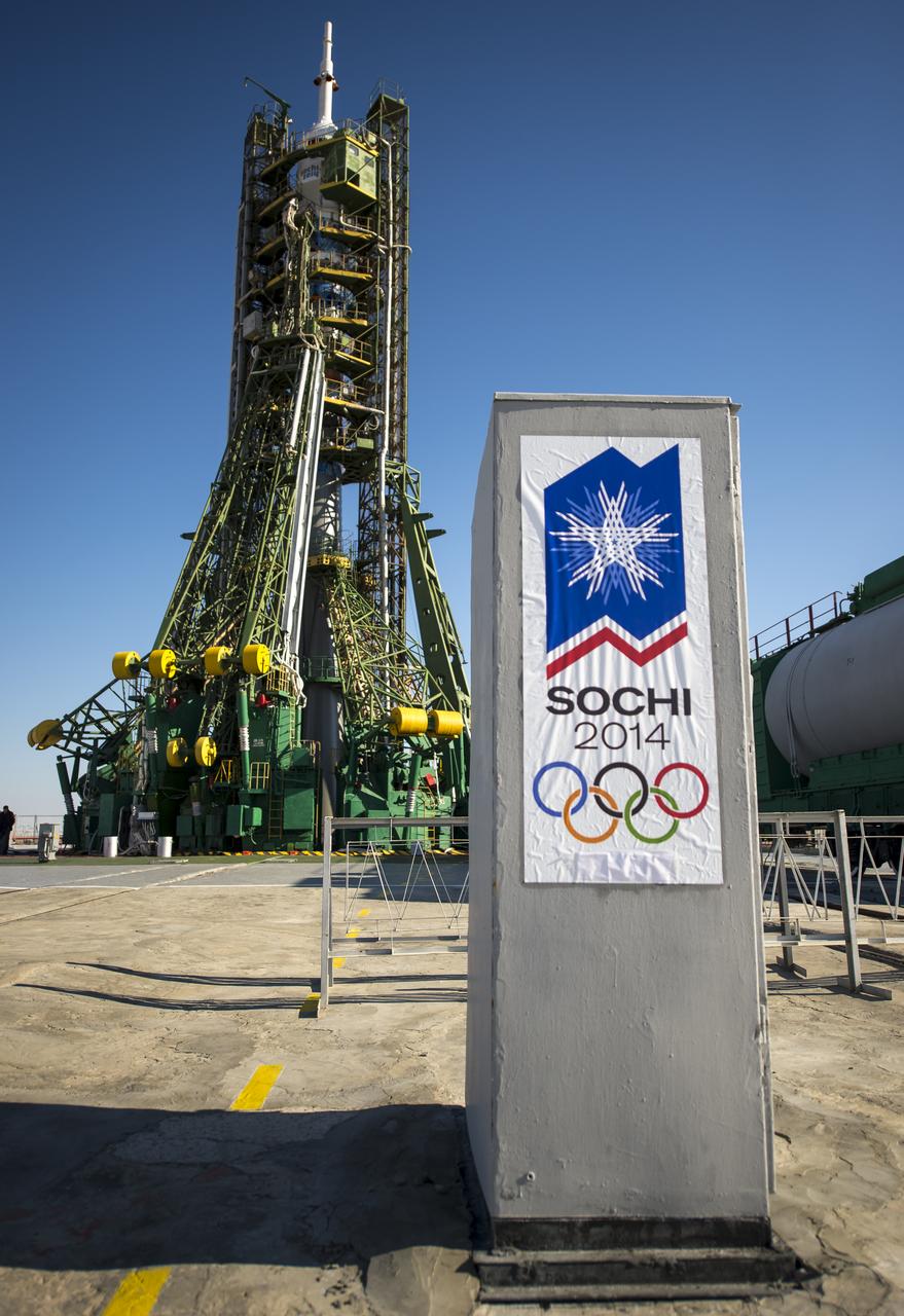 A sign for the Sochi 2014 Winter Olympics is seen at the Soyuz launch pad a day ahead of the scheduled launch of Expedition 38 Soyuz Commander Mikhail Tyurin of Roscosmos, Flight Engineer Koichi Wakata of the Japan Aerospace Exploration Agency, and, Flight Engineer Rick Mastracchio of NASA, Wednesday, Nov. 6, 2013 in Baikonur, Kazakhstan. The rocket is adorned with the logo of the Sochi Olympic Organizing Committee and other related artwork to commemorate the launch of the Olympic torch with the crew for a four-day visit to the station. The torch will return to Earth with another trio of station residents on Nov. 11 and will be part of the torch relay that ends with the lighting of the flame at the Fisht Stadium in Sochi, Russia Feb. 7 to mark the opening of the 2014 Winter Olympics. Photo Credit (NASA/Bill Ingalls)