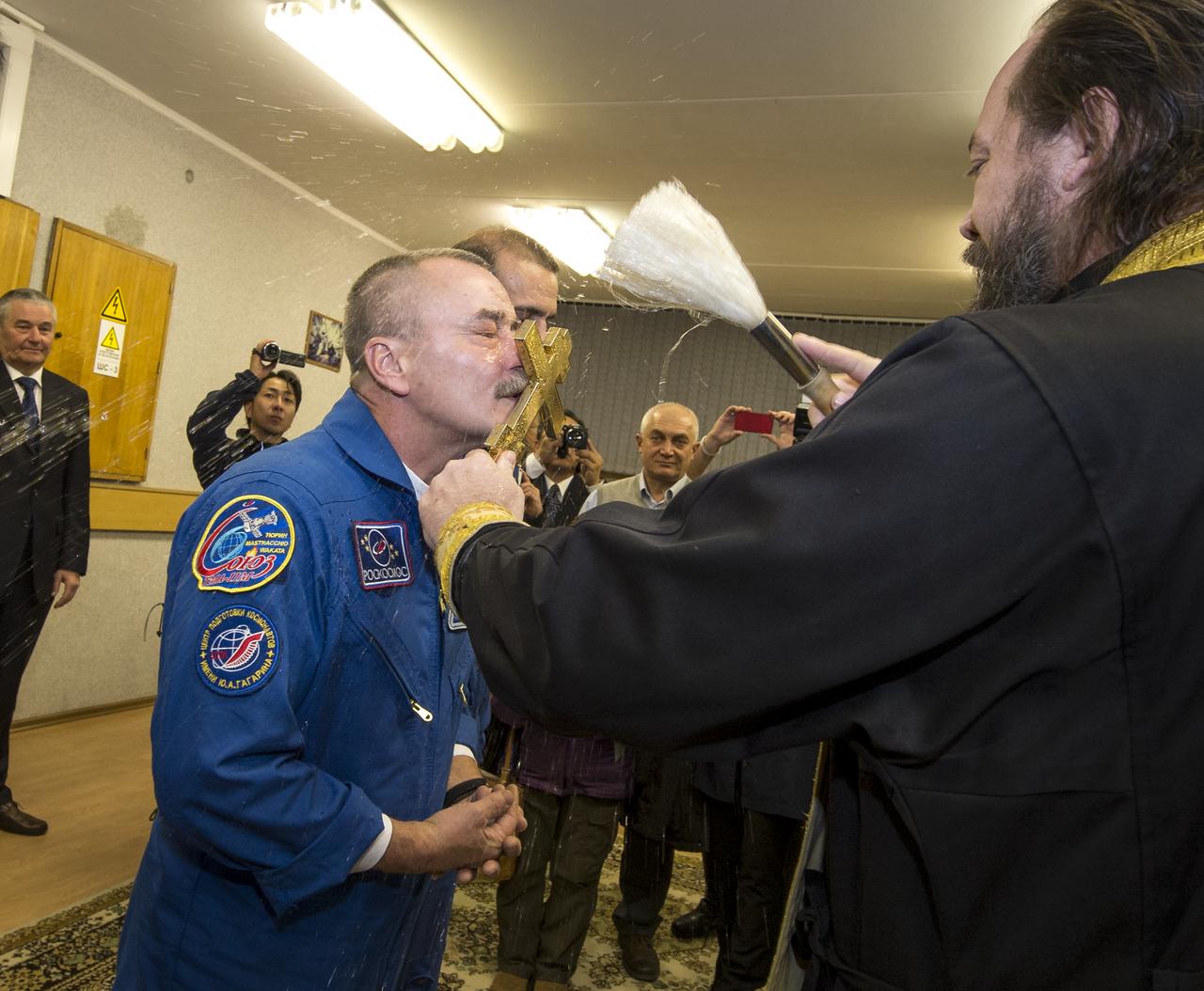 Expedition 38 Soyuz Commander Mikhail Tyurin of Roscosmos receives the traditional blessing from a Russian Orthodox priest at the Cosmonaut Hotel prior to his launch on the Soyuz rocket to the International Space Station with Flight Engineer Koichi Wakata of the Japan Aerospace Exploration Agency, and, Flight Engineer Rick Mastracchio of NASA, Thursday, Nov. 7, 2013, in Baikonur, Kazakhstan. Tyurin, Wakata, and, Mastracchio will launch in their Soyuz TMA-11M spacecraft to the International Space Station to begin a six-month mission. Photo Credit (NASA/Bill Ingalls)
