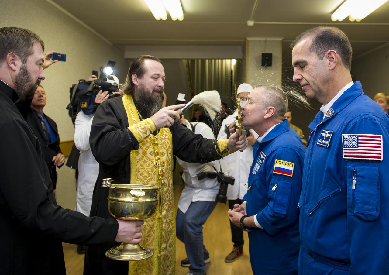 Expedition 38 Soyuz Commander Mikhail Tyurin of Roscosmos receives the traditional blessing from a Russian Orthodox priest at the Cosmonaut Hotel prior to his launch on the Soyuz rocket to the International Space Station with Flight Engineer Koichi Wakata of the Japan Aerospace Exploration Agency, and, Flight Engineer Rick Mastracchio of NASA, Thursday, Nov. 7, 2013, in Baikonur, Kazakhstan. Tyurin, Wakata, and, Mastracchio will launch in their Soyuz TMA-11M spacecraft to the International Space Station to begin a six-month mission. Photo Credit: (NASA/GCTC/Irina Peshkova)