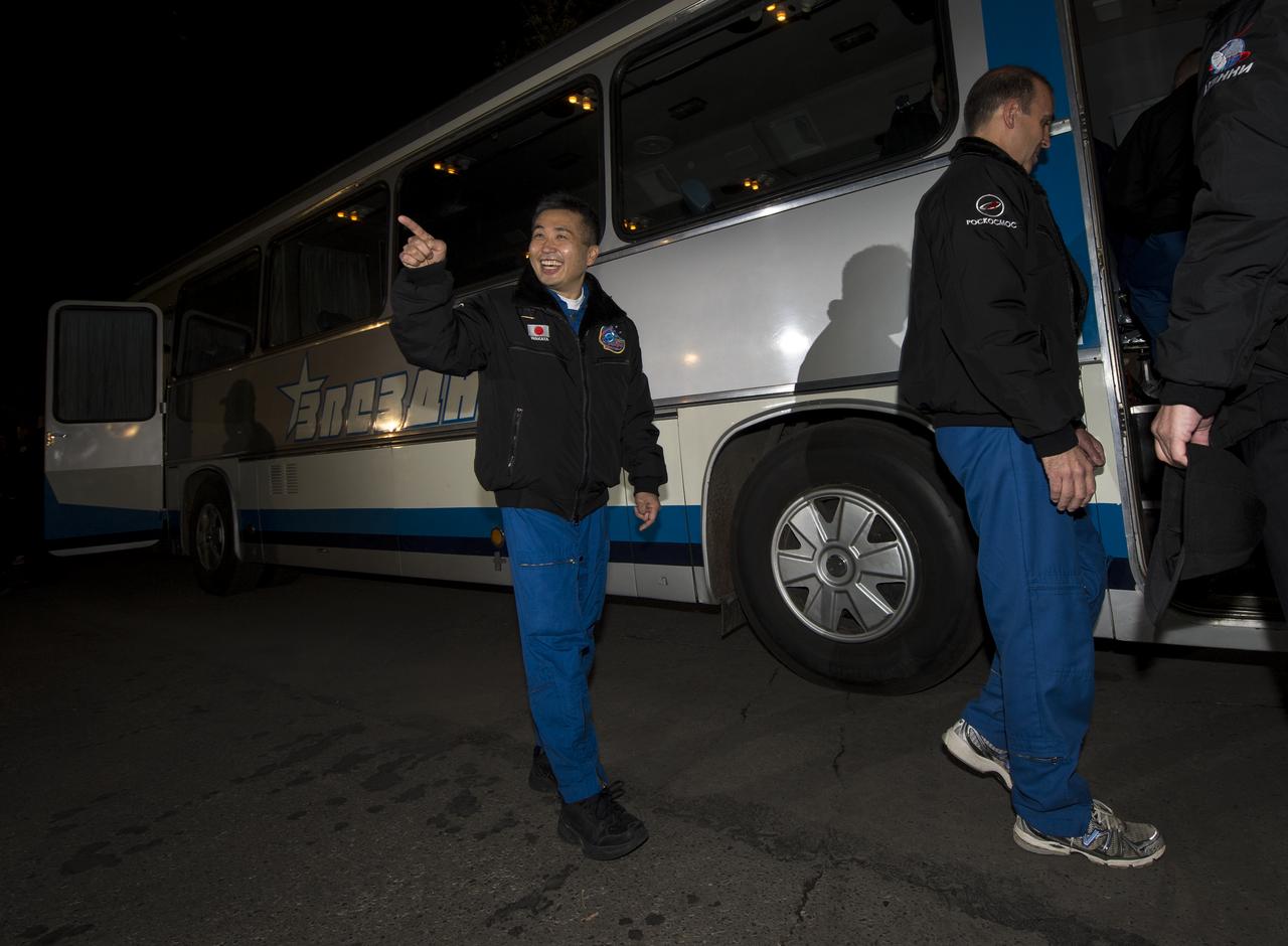 Expedition 38 Flight Engineer Koichi Wakata of the Japan Aerospace Exploration Agency recognizes someone in the crowd as he and fellow crew mates, Flight Engineer Rick Mastracchio of NASA, and, Soyuz Commander Mikhail Tyurin of Roscosmos, depart the Cosmonaut hotel ahead of their launch on a Soyuz rocket to the International Space Station, Thursday, Nov. 7, 2013, in Baikonur, Kazakhstan. Photo Credit: (NASA/Bill Ingalls)