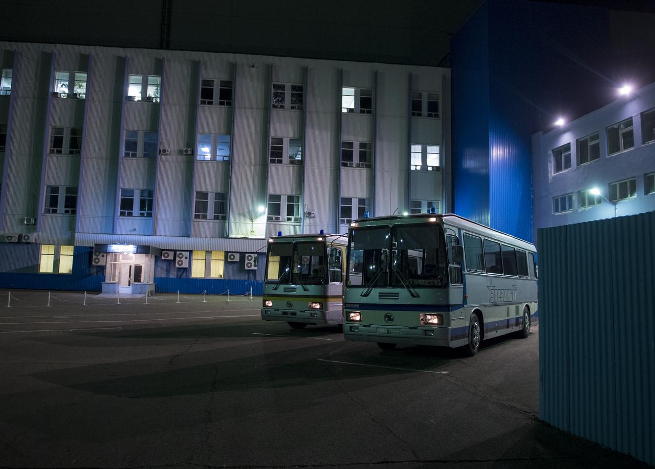 The buses that provide transport for the prime and backup Soyuz crews are seen parked outside of building 254 in the Baikonur Cosmodrome after having brought Expedition 38 Soyuz Commander Mikhail Tyurin of Roscosmos, Flight Engineer Koichi Wakata of the Japan Aerospace Exploration Agency, and, Flight Engineer Rick Mastracchio of NASA, to the building for them to suit up for launch, Thursday, Nov. 7, 2013, in Baikonur, Kazakhstan. Tyurin, Wakata, and, Mastracchio will launch in their Soyuz TMA-11M spacecraft to the International Space Station to begin a six-month mission. Photo Credit (NASA/Bill Ingalls)