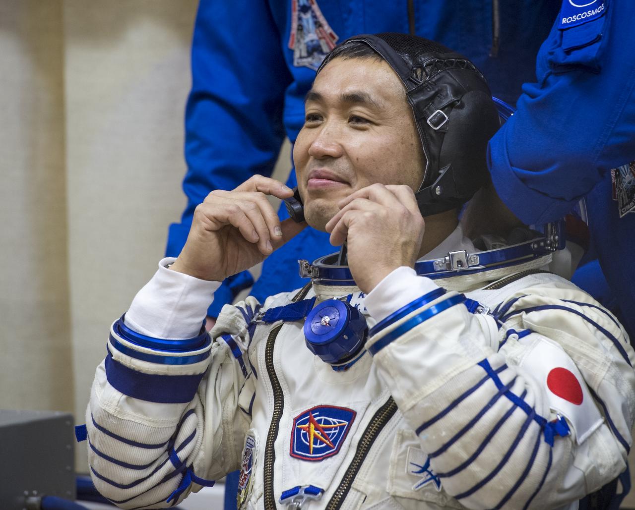 Expedition 38 Flight Engineer Koichi Wakata of the Japan Aerospace Exploration Agency is seen through glass as he and fellow crew mates, Soyuz Commander Mikhail Tyurin of Roscosmos, and, Flight Engineer Rick Mastracchio of NASA, have their Russian Sokol suits pressure checked a few hours ahead of their launch, Thursday, Nov. 7, 2013, in Baikonur, Kazakhstan. Tyurin, Wakata, and, Mastracchio will launch in their Soyuz TMA-11M spacecraft to the International Space Station to begin a six-month mission. Photo Credit (NASA/Bill Ingalls)