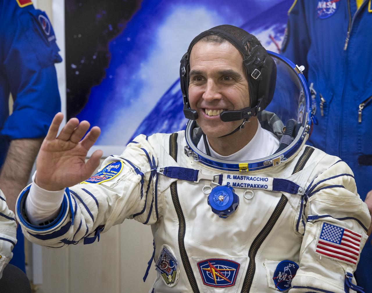 Expedition 38 Flight Engineer Rick Mastracchio of NASA is seen through glass as he and fellow crew mates, Soyuz Commander Mikhail Tyurin of Roscosmos, and, Flight Engineer Koichi Wakata of the Japan Aerospace Exploration Agency, have their Russian Sokol suits pressure checked a few hours ahead of their launch, Thursday, Nov. 7, 2013, in Baikonur, Kazakhstan. Tyurin, Wakata, and, Mastracchio will launch in their Soyuz TMA-11M spacecraft to the International Space Station to begin a six-month mission. Photo Credit (NASA/Bill Ingalls)