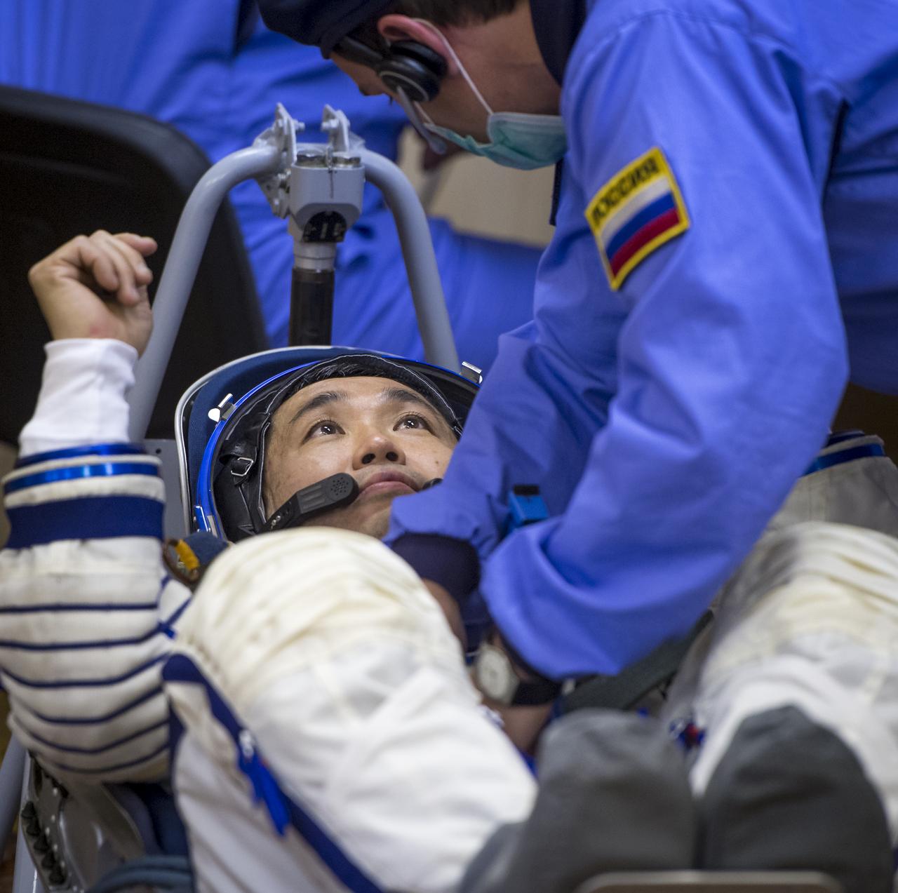 Expedition 38 Flight Engineer Koichi Wakata of the Japan Aerospace Exploration Agency is seen through glass as he and fellow crew mates, Soyuz Commander Mikhail Tyurin of Roscosmos, and, Flight Engineer Rick Mastracchio of NASA, have their Russian Sokol suits pressure checked a few hours ahead of their launch, Thursday, Nov. 7, 2013, in Baikonur, Kazakhstan. Tyurin, Wakata, and, Mastracchio will launch in their Soyuz TMA-11M spacecraft to the International Space Station to begin a six-month mission. Photo Credit (NASA/Bill Ingalls)