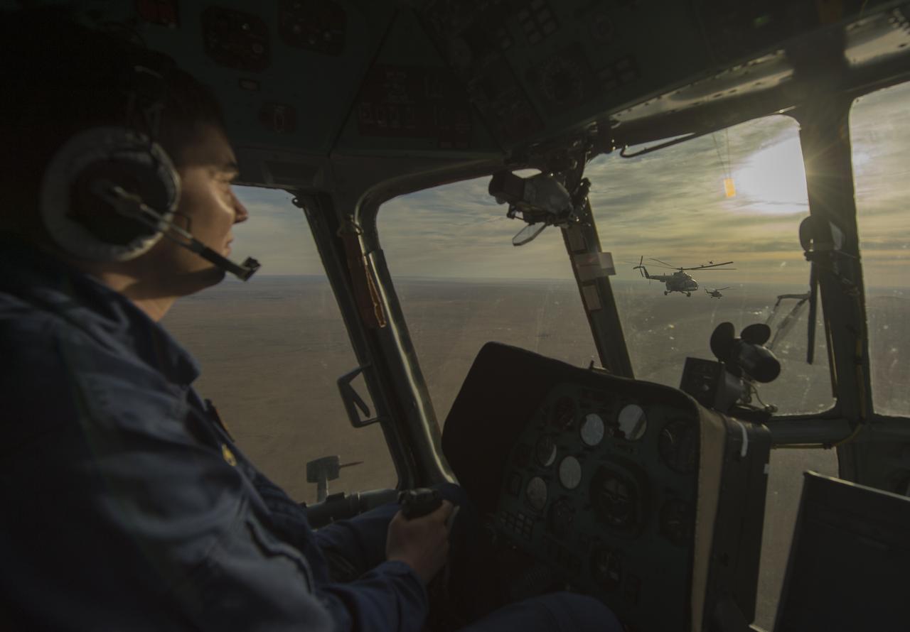 View from the cockpit of one of twelve Russian search and rescue helicopters as they fly from the city of Karaganda to Zhezkazgan in Kazakhstan, Sunday, Nov. 10, 2013, a day ahead of the scheduled landing of the Soyuz TMA-09M spacecraft with the Expedition 37 crew.  Exp. 37 Commander Fyodor Yurchikhin of the Russian Federal Space Agency (Roscosmos), Flight Engineer Karen Nyberg of NASA and Flight Engineer Luca Parmitano of the European Space Agency are returning to Earth after five and a half months on the International Space Station. Photo Credit: (NASA/Carla Cioffi)