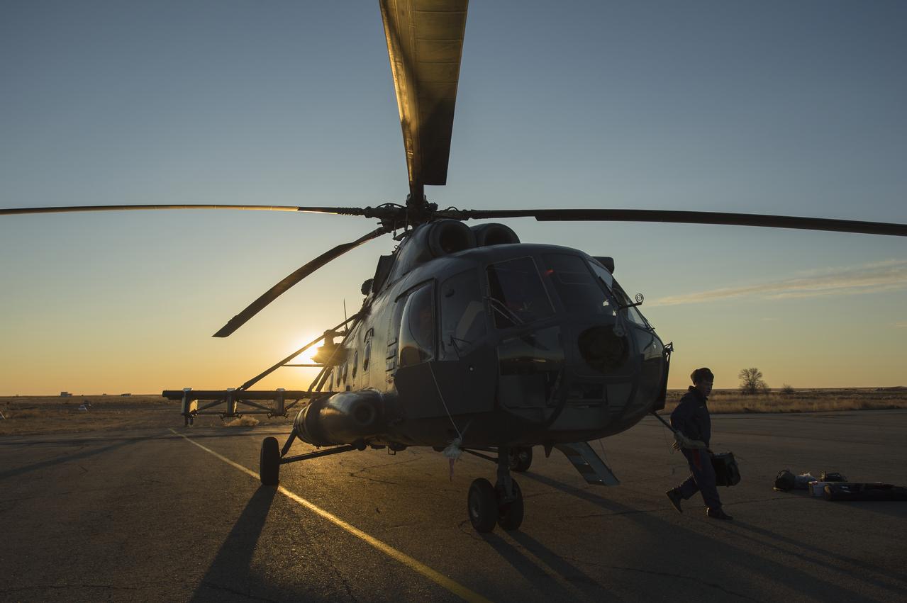 A member of Russian search and rescue exits a helicopter moments after landing at Zhezkazgan airport in Kazakhstan, Sunday, Nov. 10, 2013, a day ahead of the scheduled landing of the Soyuz TMA-09M spacecraft with Expedition 37 Commander Fyodor Yurchikhin of the Russian Federal Space Agency (Roscosmos), Flight Engineer Karen Nyberg of NASA and Flight Engineer Luca Parmitano of the European Space Agency. Yurchikhin, Nyberg and Parmitano are returning to Earth after five and a half months on the International Space Station. Photo Credit: (NASA/Carla Cioffi)