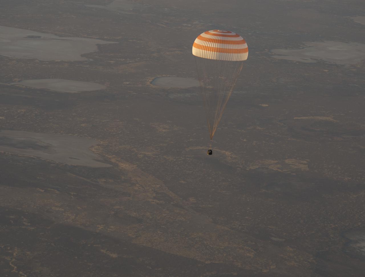 The Soyuz TMA-09M is seen moments before it lands southeast of the town of Zhezkazgan, Kazakstan with the crew of Expedition 37, Monday, Nov. 11, 2013.  Expedition 37 Commander Fyodor Yurchikhin of the Russian Federal Space Agency (Roscosmos), Flight Engineer Karen Nyberg of NASA and Flight Engineer Luca Parmitano of the European Space Agency are returning to Earth after five and a half months on the International Space Station. Photo Credit: (NASA/Carla Cioffi)
