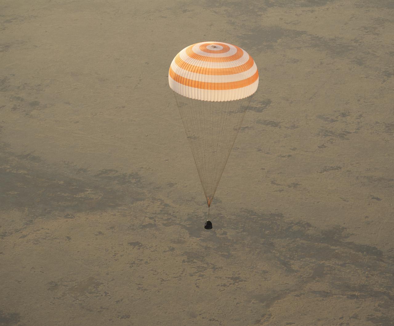 The Soyuz TMA-09M is seen moments before it lands southeast of the town of Zhezkazgan, Kazakhstan with the crew of Expedition 37, Monday, Nov. 11, 2013.  Expedition 37 Commander Fyodor Yurchikhin of the Russian Federal Space Agency (Roscosmos), Flight Engineer Karen Nyberg of NASA and Flight Engineer Luca Parmitano of the European Space Agency are returning to Earth after five and a half months on the International Space Station. Photo Credit: (NASA/Carla Cioffi)