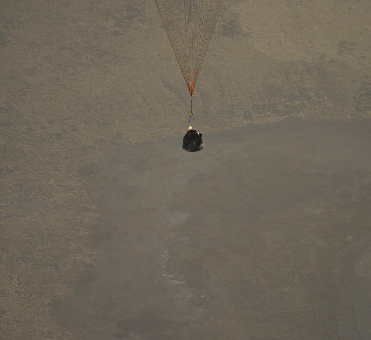 The Soyuz TMA-09M is seen moments before it lands southeast of the town of Zhezkazgan, Kazakhstan with the crew of Expedition 37, Monday, Nov. 11, 2013.  Expedition 37 Commander Fyodor Yurchikhin of the Russian Federal Space Agency (Roscosmos), Flight Engineer Karen Nyberg of NASA and Flight Engineer Luca Parmitano of the European Space Agency are returning to Earth after five and a half months on the International Space Station. Photo Credit: (NASA/Carla Cioffi)