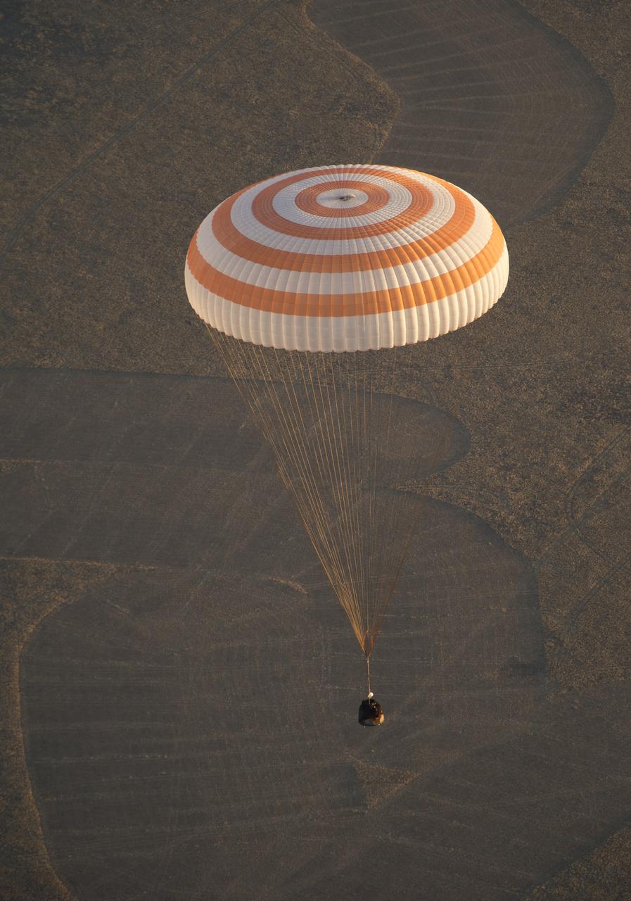 The Soyuz TMA-09M is seen moments before it lands southeast of the town of Zhezkazgan, Kazakhstan with the crew of Expedition 37, Monday, Nov. 11, 2013.  Expedition 37 Commander Fyodor Yurchikhin of the Russian Federal Space Agency (Roscosmos), Flight Engineer Karen Nyberg of NASA and Flight Engineer Luca Parmitano of the European Space Agency are returning to Earth after five and a half months on the International Space Station. Photo Credit: (NASA/Carla Cioffi)