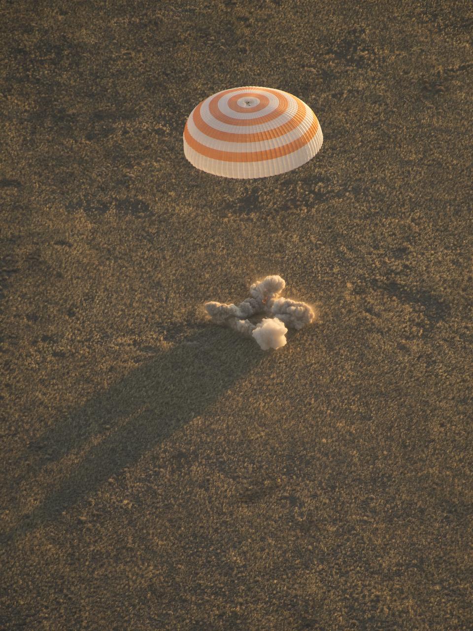 The Soyuz TMA-09M is seen moments before it lands southeast of the town of Zhezkazgan, Kazakhstan with the crew of Expedition 37, Monday, Nov. 11, 2013.  Expedition 37 Commander Fyodor Yurchikhin of the Russian Federal Space Agency (Roscosmos), Flight Engineer Karen Nyberg of NASA and Flight Engineer Luca Parmitano of the European Space Agency are returning to Earth after five and a half months on the International Space Station. Photo Credit: (NASA/Carla Cioffi)