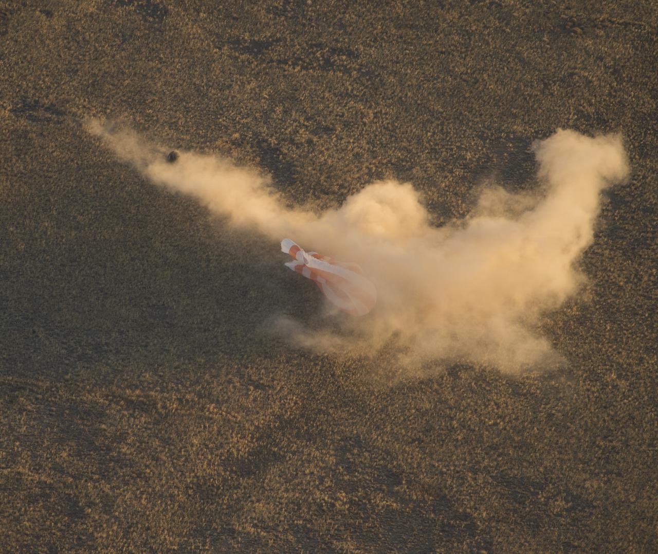 The Soyuz TMA-09M is seen moments before it lands southeast of the town of Zhezkazgan, Kazakhstan with the crew of Expedition 37, Monday, Nov. 11, 2013.  Expedition 37 Commander Fyodor Yurchikhin of the Russian Federal Space Agency (Roscosmos), Flight Engineer Karen Nyberg of NASA and Flight Engineer Luca Parmitano of the European Space Agency are returning to Earth after five and a half months on the International Space Station. Photo Credit: (NASA/Carla Cioffi)