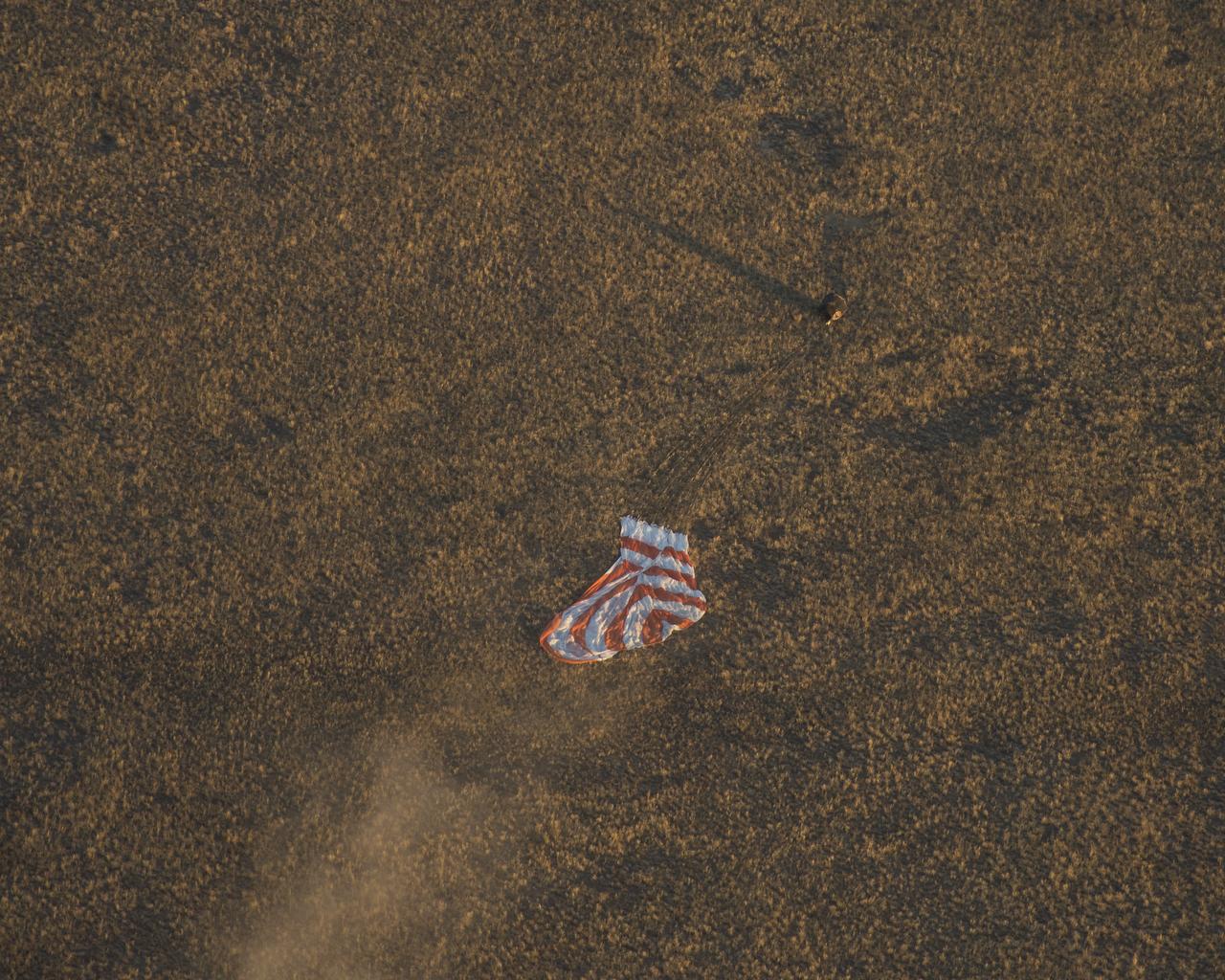 The Soyuz TMA-09M is seen moments before it lands southeast of the town of Zhezkazgan, Kazakhstan with the crew of Expedition 37, Monday, Nov. 11, 2013.  Expedition 37 Commander Fyodor Yurchikhin of the Russian Federal Space Agency (Roscosmos), Flight Engineer Karen Nyberg of NASA and Flight Engineer Luca Parmitano of the European Space Agency are returning to Earth after five and a half months on the International Space Station. Photo Credit: (NASA/Carla Cioffi)