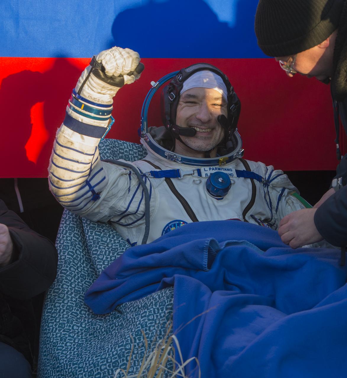Expedition 37 Luca Parmitano of ESA (European Space Agency) pumps his fist minutes after his landing in the Soyuz TMA-09M spacecraft in a remote area outside the town of Zhezkazgan, Kazakhstan, on Monday, Nov. 11, 2013. Parmitano, Expedition 37 Commander Fyodor Yurchikhin of the Russian Federal Space Agency (Roscosmos) and NASA Flight Engineer Karen Nyberg returned to earth after five and a half months on the International Space Station. Photo Credit: (NASA/Carla Cioffi)