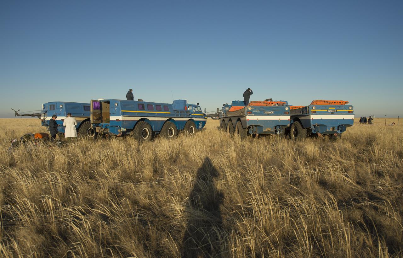 Russian Search and Rescue all-terrain vehicles are seen waiting to ferry the Expedition 37 crew to their respective helicopters in a remote area outside the town of Zhezkazgan, Kazakhstan, on Monday, Nov. 11, 2013.  The crew of Expedition 37 Commander Fyodor Yurchikhin of Roscosmos, Flight Engineers Karen Nyberg of NASA and Luca Parmitano of Italy returned to earth after five and a half months on the International Space Station. Photo Credit: (NASA/Carla Cioffi)