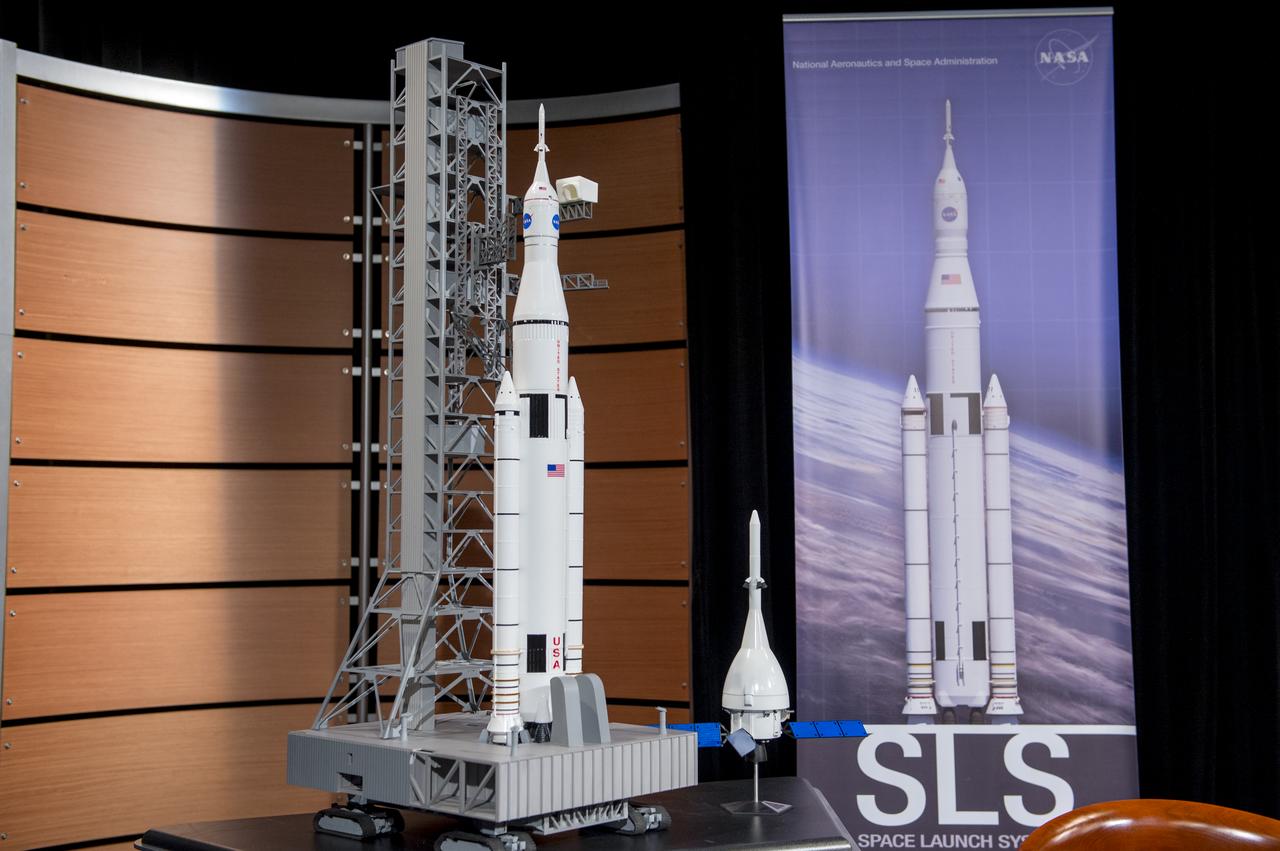 Models of the Space Launch System and Orion spacecraft are displayed during a panel discussion on deep space eploration at the Newseum on Tuesday, November 12, 2013 in Washington. Photo Credit: (NASA/Jay Westcott)