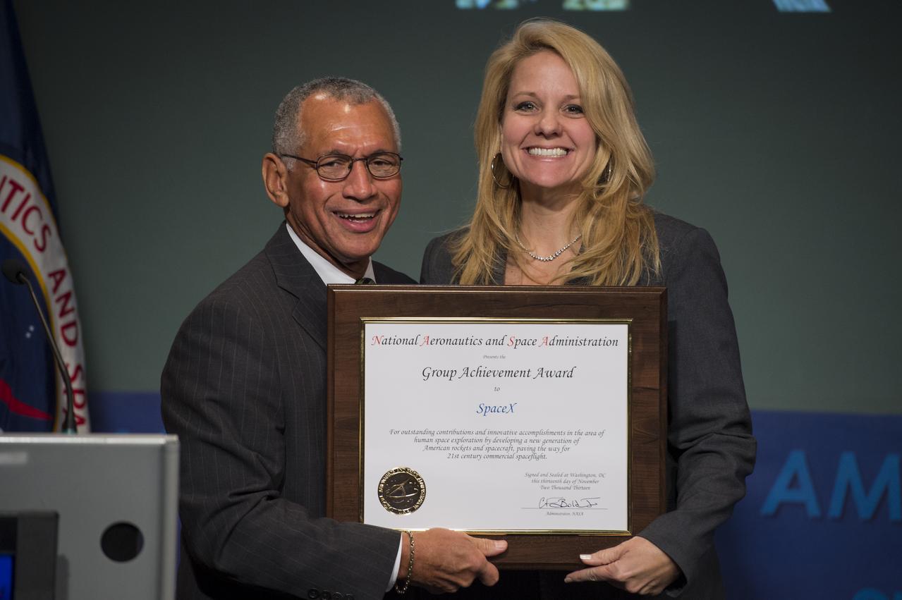 NASA Administrator Charles Bolden, left, presents NASA's Group Achievement Award to Gwynne Shotwell, President, SpaceX, at NASA Headquarters in Washington on Thursday, November 13, 2013. Shotwell received the award for outstanding contributions and innovative accomplishments in the completion of the Commercial Orbital Transportation Services (COTS) initiative. Through COTS, NASA's partners Space Exploration Technologies Corp. (SpaceX) and Orbital Sciences Corp., developed new U.S. rockets and spacecraft, launched from U.S. soil, capable of transporting cargo to low-Earth orbit and the International Space Station. Photo Credit: (NASA/Jay Westcott)