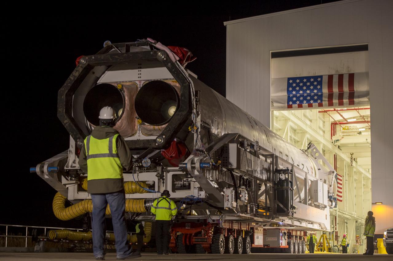 An Orbital Science Corporation Antares rocket is seen as it is rolled out to launch Pad-0A at NASA's Wallops Flight Facility Tuesday, December 17, 2013 in advance of a Thursday launch, Wallops Island, VA. The Antares will launch a Cygnus spacecraft on a cargo resupply mission to the International Space Station. The Orbital-1 mission is Orbital Sciences' first contracted cargo delivery flight to the space station for NASA. Among the cargo aboard Cygnus set to launch to the space station are science experiments, crew provisions, spare parts and other hardware. Launch is scheduled for 9:19 p.m. EST on Thursday, Dec. 19. Weather permitting, it may be widely visible along the east coast of the United States. Photo Credit: (NASA/Bill Ingalls)