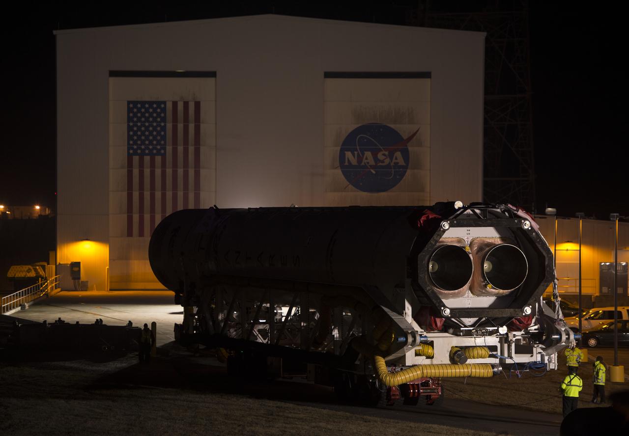 An Orbital Science Corporation Antares rocket is seen as it is rolled out to launch Pad-0A at NASA's Wallops Flight Facility Tuesday, December 17, 2013 in advance of a Thursday launch, Wallops Island, VA. The Antares will launch a Cygnus spacecraft on a cargo resupply mission to the International Space Station. The Orbital-1 mission is Orbital Sciences' first contracted cargo delivery flight to the space station for NASA. Among the cargo aboard Cygnus set to launch to the space station are science experiments, crew provisions, spare parts and other hardware. Launch is scheduled for 9:19 p.m. EST on Thursday, Dec. 19. Weather permitting, it may be widely visible along the east coast of the United States. Photo Credit: (NASA/Bill Ingalls)